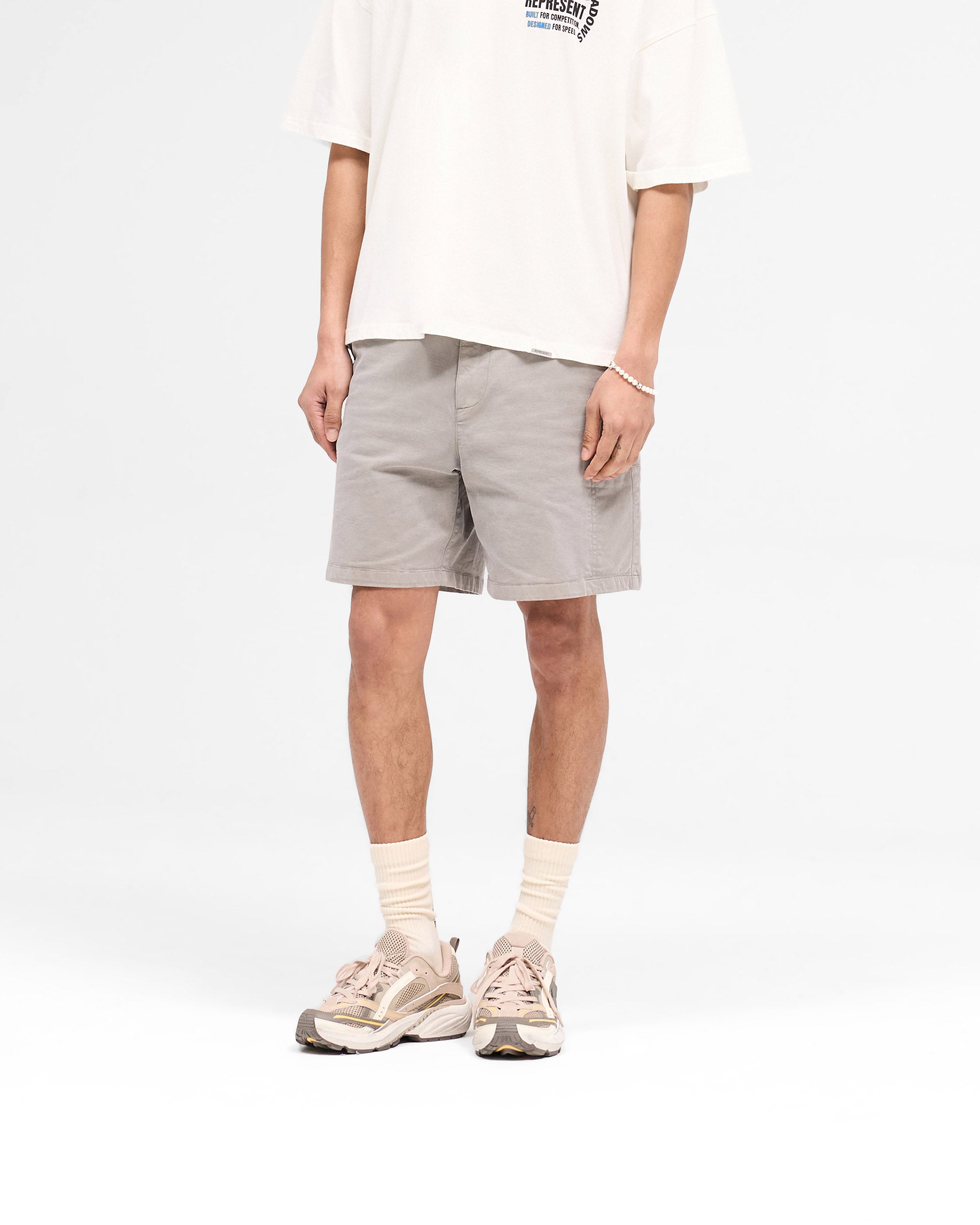 Back product image of mens taupe shorts on a plain white background | Season Cargo Short in Washed Taupe | Cargo shorts with welt pockets and YKK fly | SS25 Shorts | Represent Clo