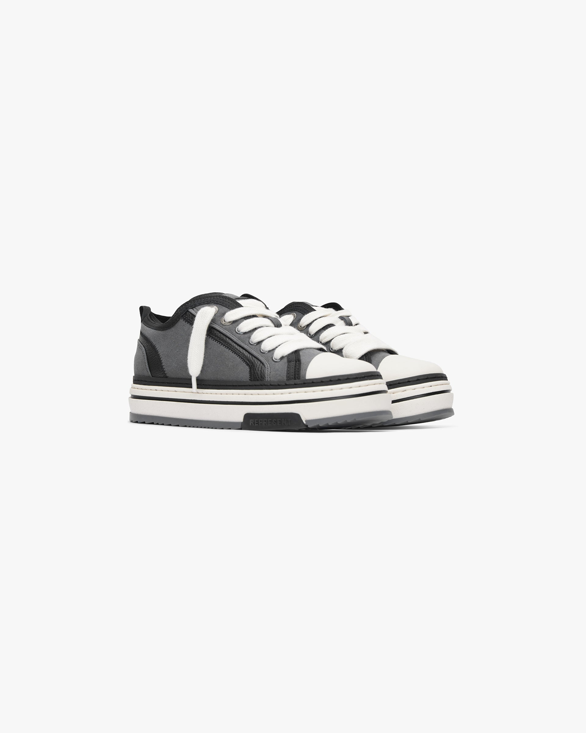 Back product image of a mens black sneaker on a plain white background | HTN X Low in Black Textured | Low top sneaker with washed canvas and tumbled leather | SS24 Footwear | Represent Clo