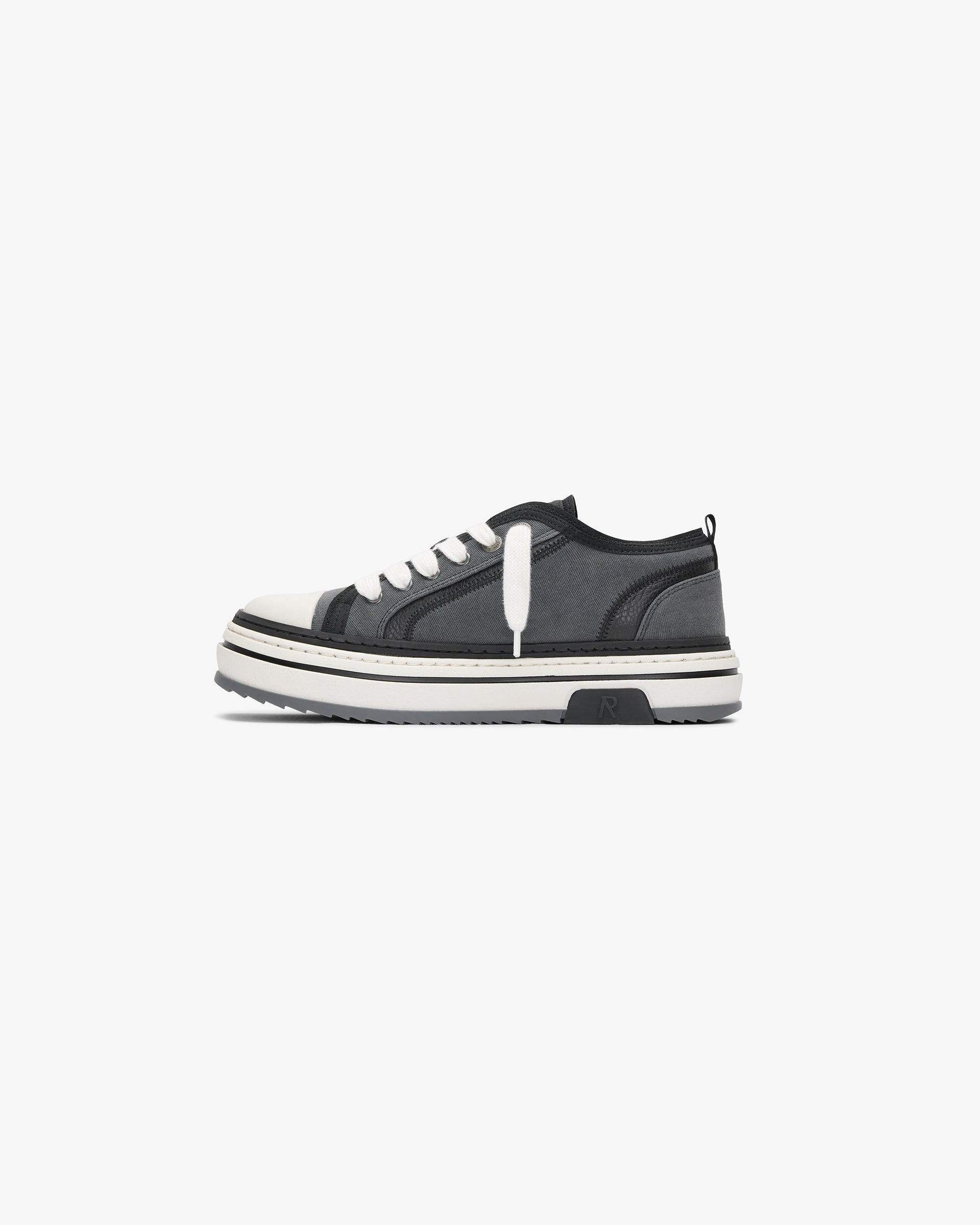 Close-up image of mens black sneakers on a plain white background | HTN X Low in Black Textured | Low top sneakers with chunky rubber outsole | SS24 Footwear | Represent Clo