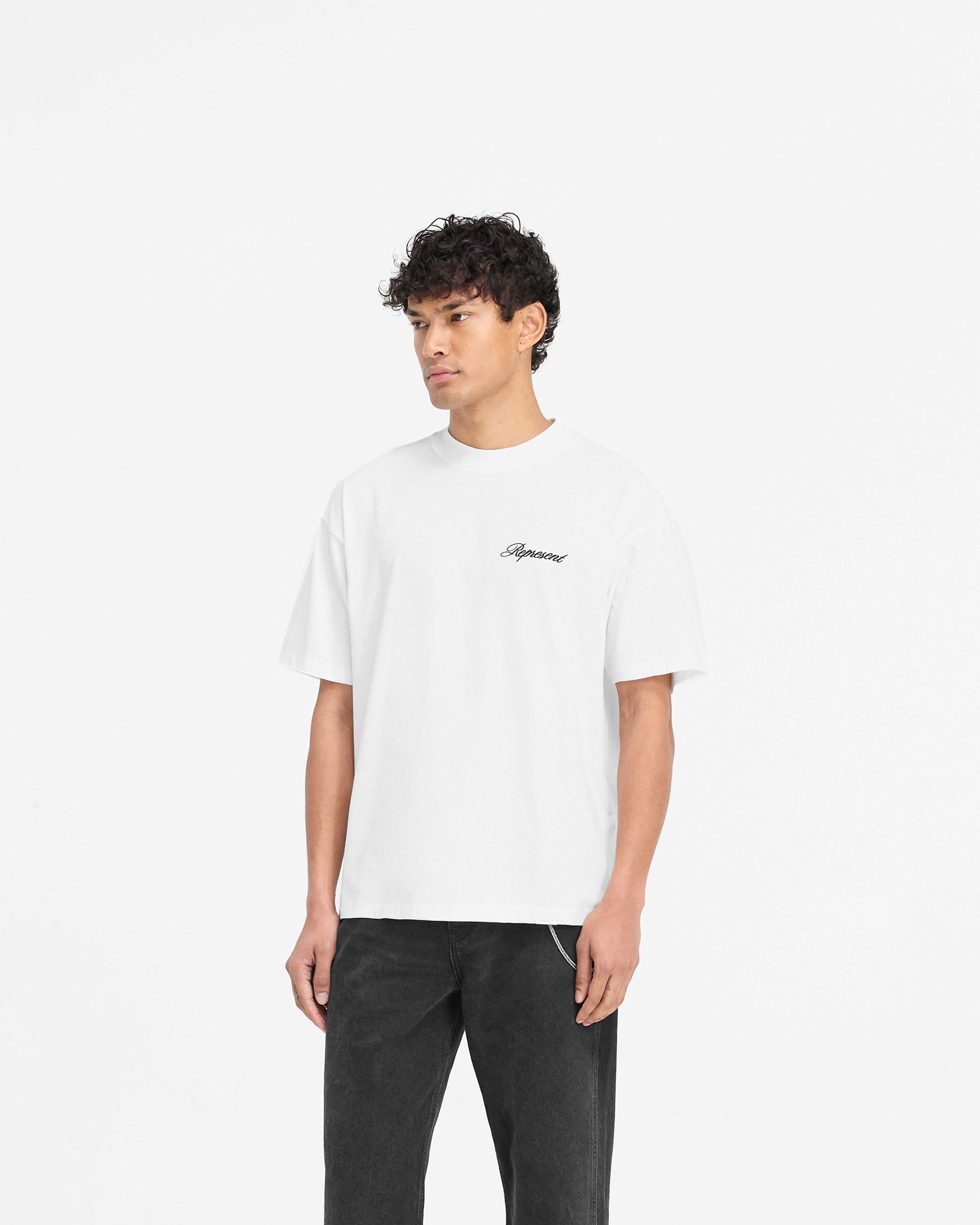 Back product image of a mens white t-shirt on a plain white background | Script Logo T-Shirt in Flat White | Slightly oversized t-shirt with high build embroidery | PRE SS25 T-Shirts | Represent Clo