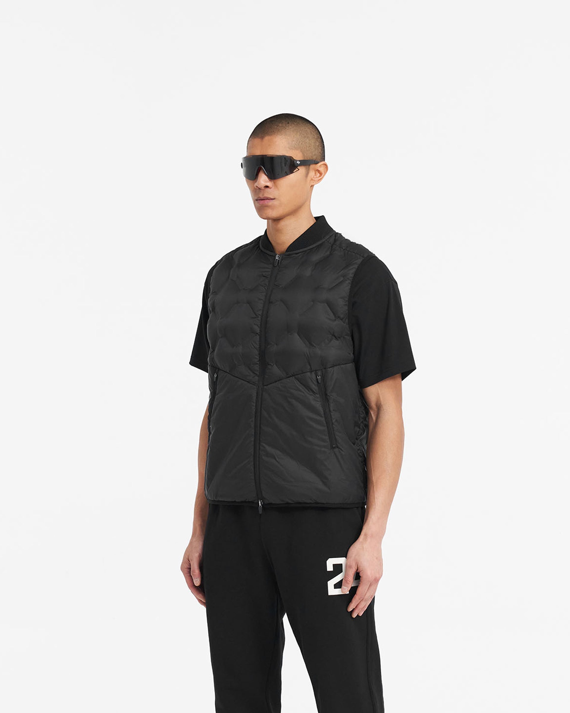 Man wearing a black lightweight gilet on a plain white background | 247 Lightweight Gilet in Black | Nylon gilet with heat sealed quilting | 247 Outerwear | Represent Clo