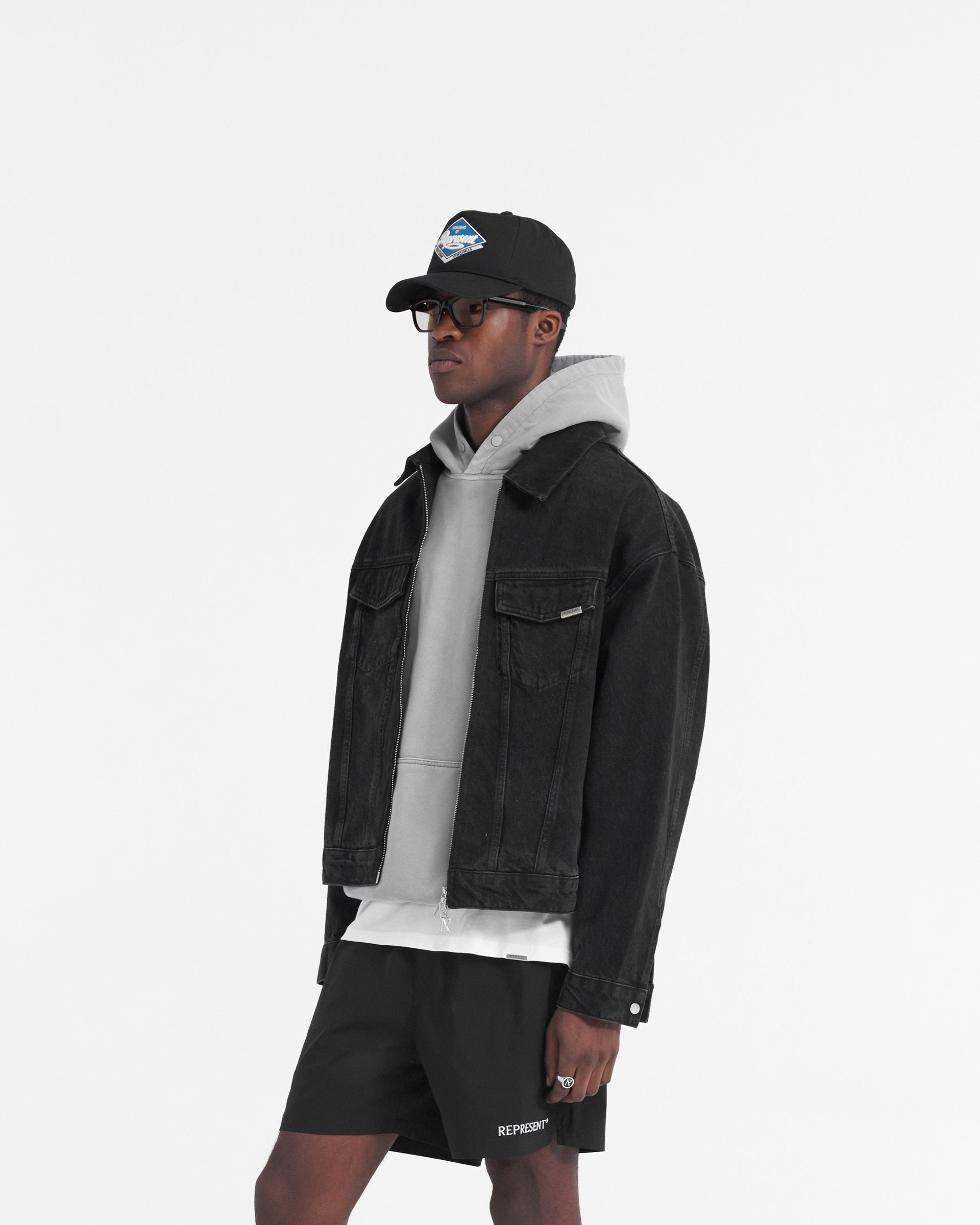 Back product image of a mens black denim jacket on a plain white background | R4 Denim Jacket in Black | Slightly oversized denim jacket with zip closure and chest pockets | SS24 Denim | Represent Clo