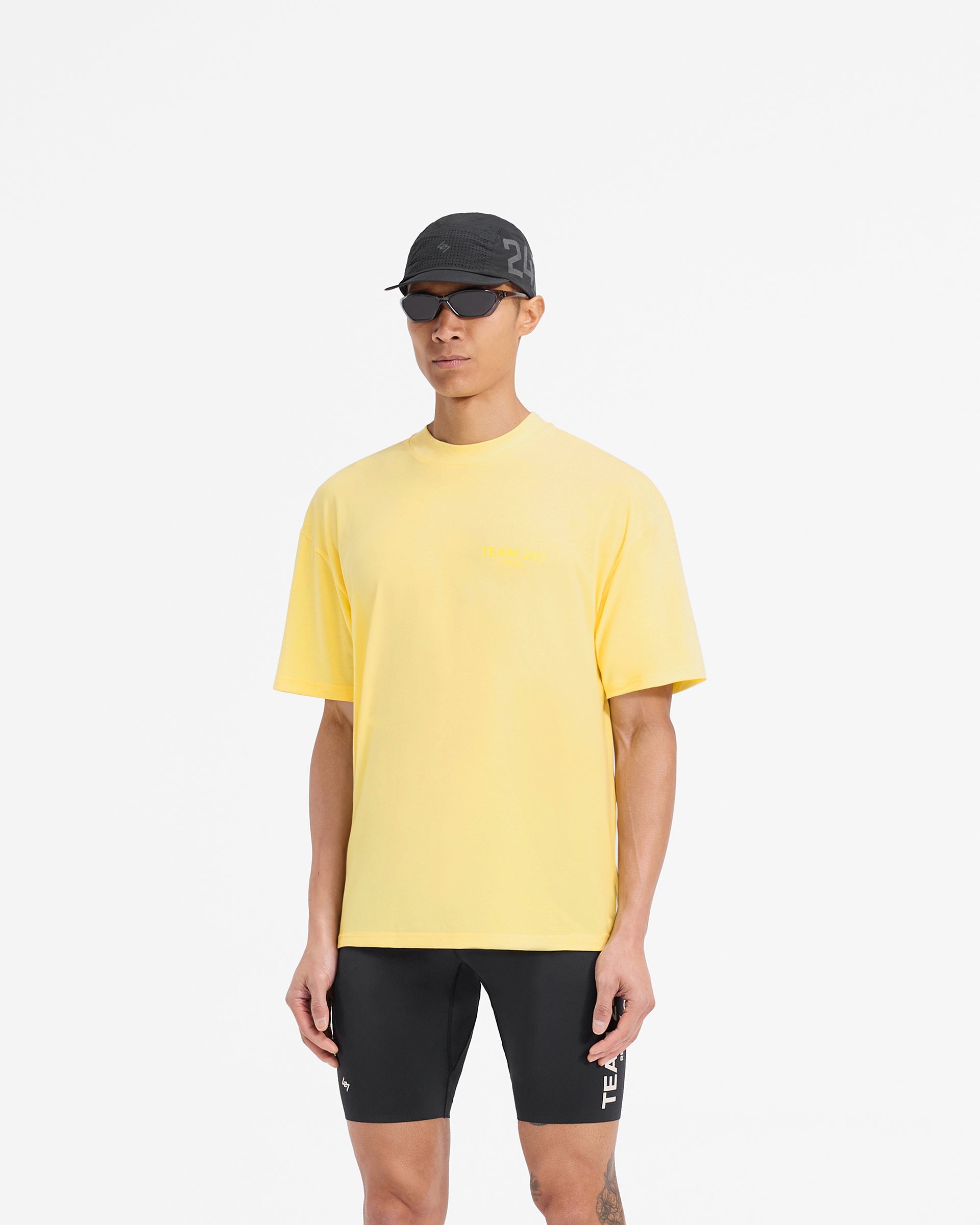 Man wearing a yellow oversized t-shirt on a plain white background | Team 247 Oversized T-Shirt in Lemon | Quick drying lightweight t-shirt | 247 T-Shirts | Represent Clo