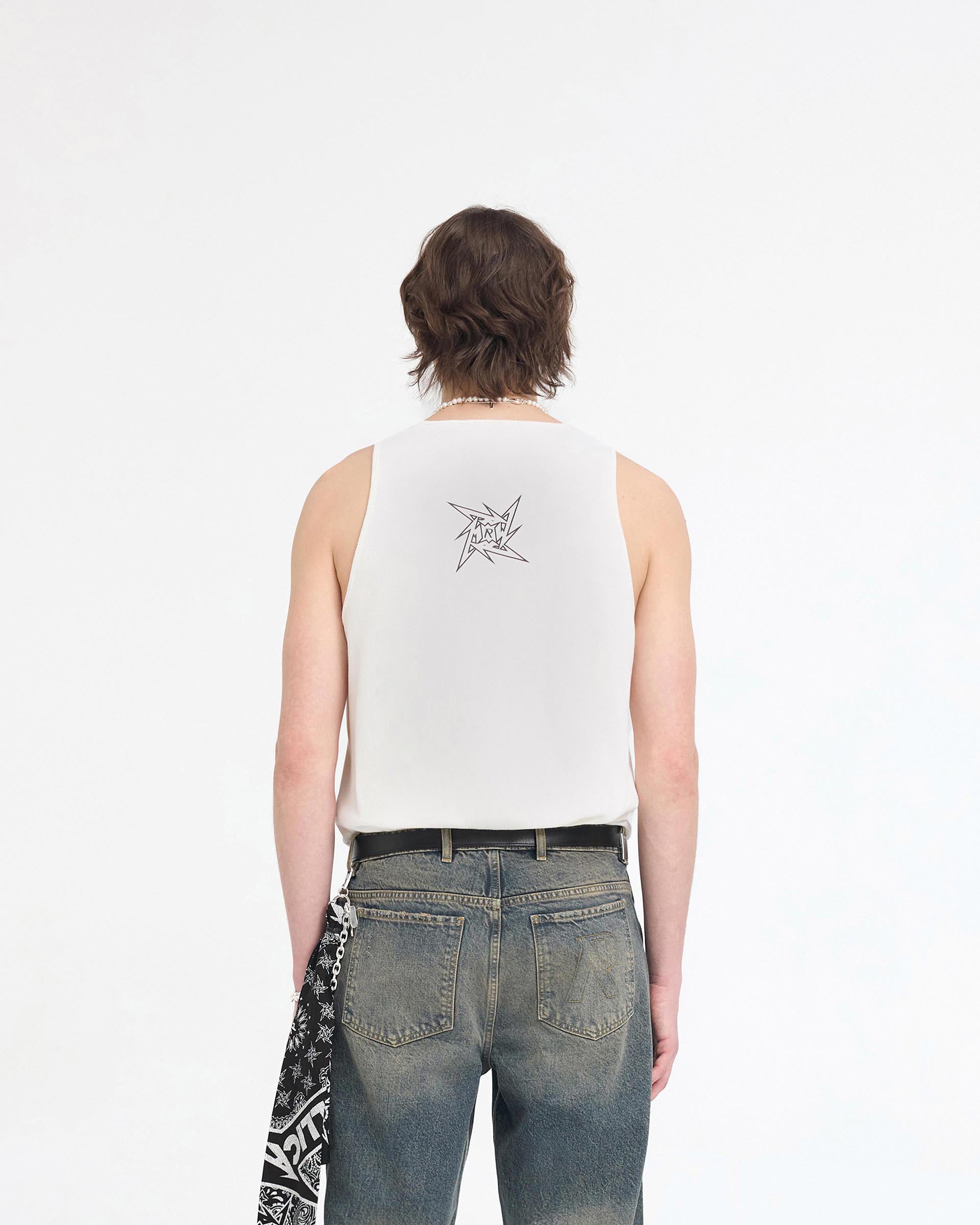 Man wearing a white vest on a plain white background | Represent X Metallica Local Crew Vest in Flat White | Ribbed vest with Metallica logos | SS24 T-Shirts | Represent Clo