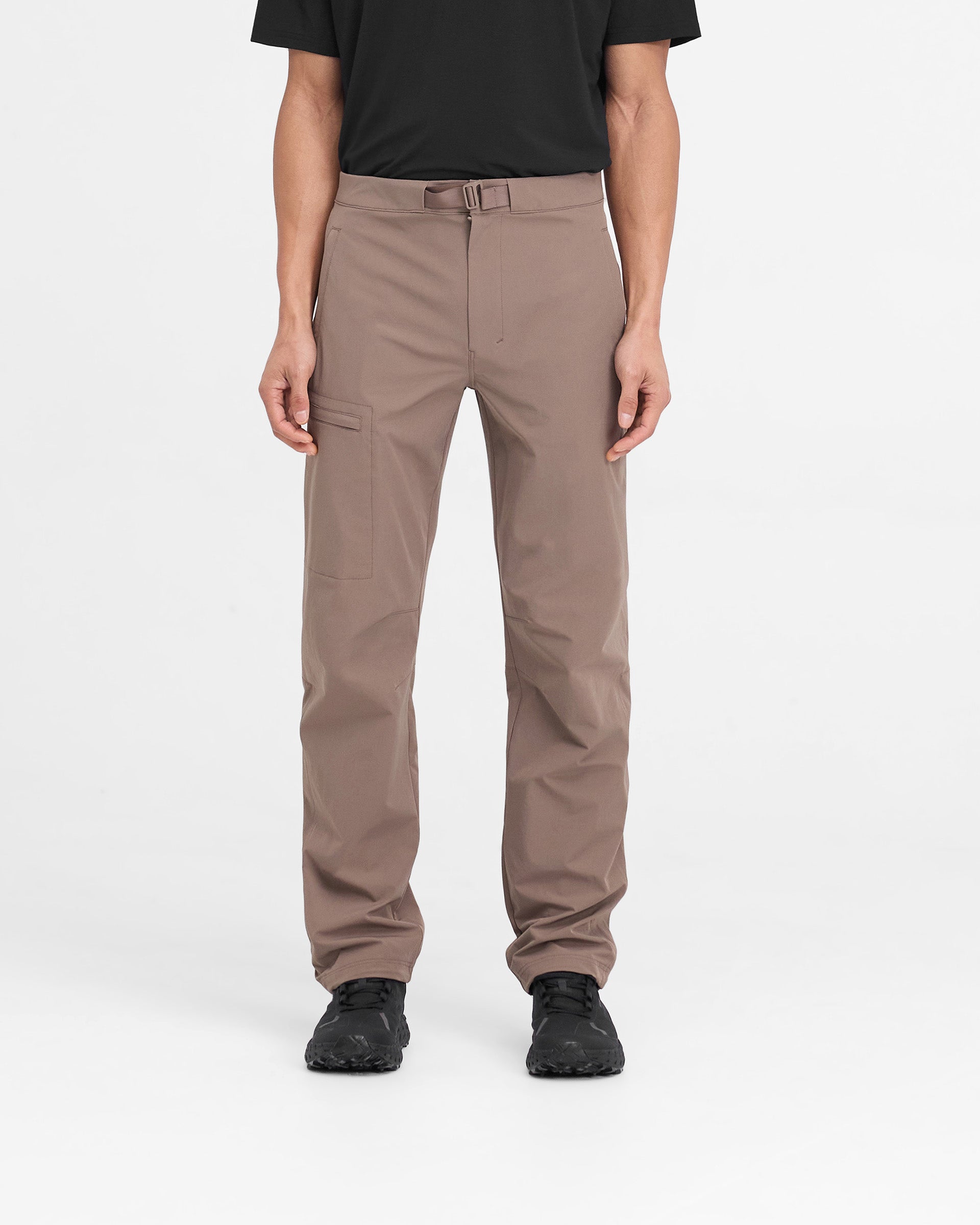 Man wearing mens umber pants on a plain white background | 247 Mission Pant in Umber | Straight leg nylon pants with zip pockets and built-in belt | 247 Pants | Represent Clo