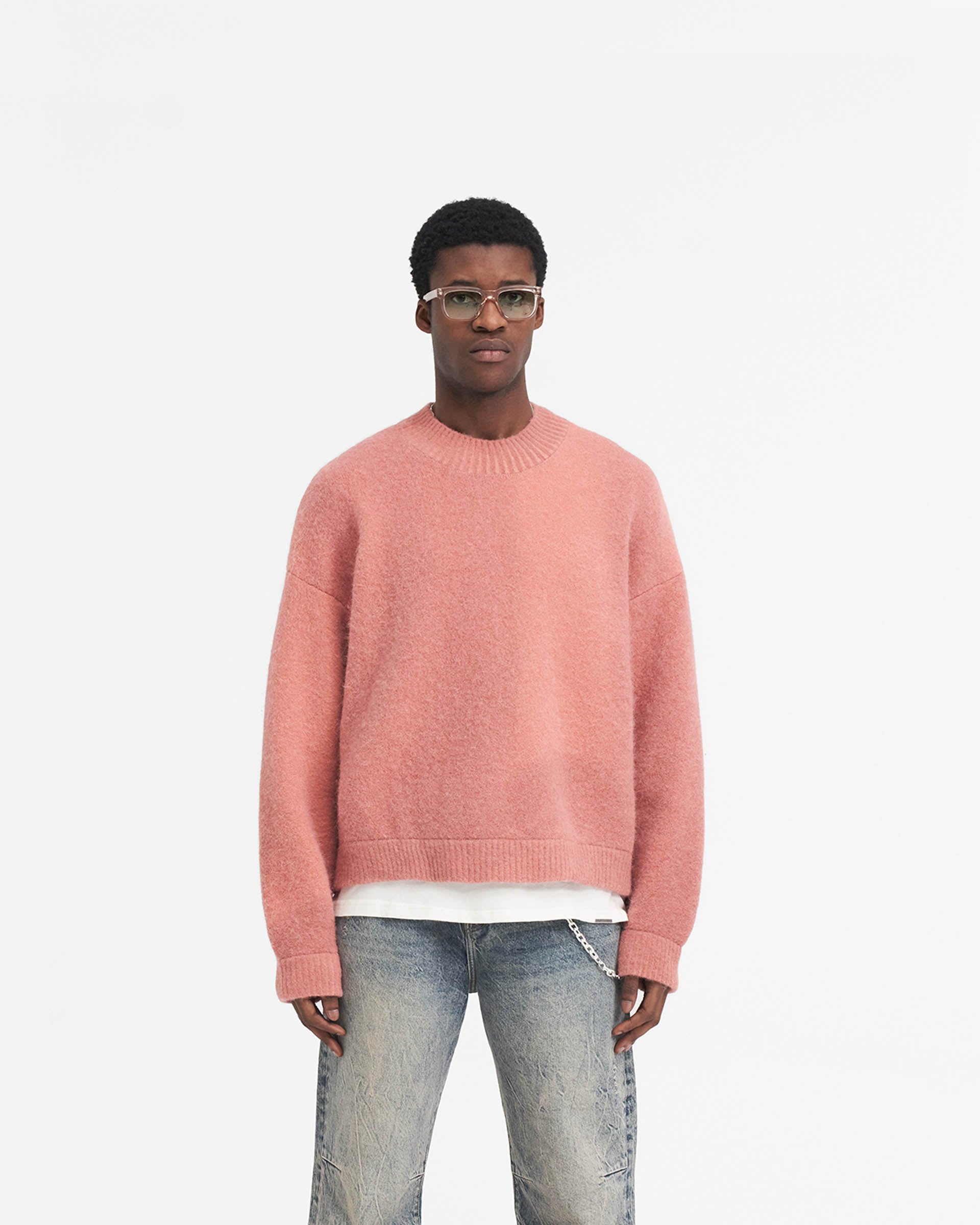 Man wearing a multicoloured sweater on a plain white background | Sprayed Horizons Sweater in Sunrise | Boxy oversized fit alpaca and wool blend sweater | SS24 Knitwear | Represent Clo