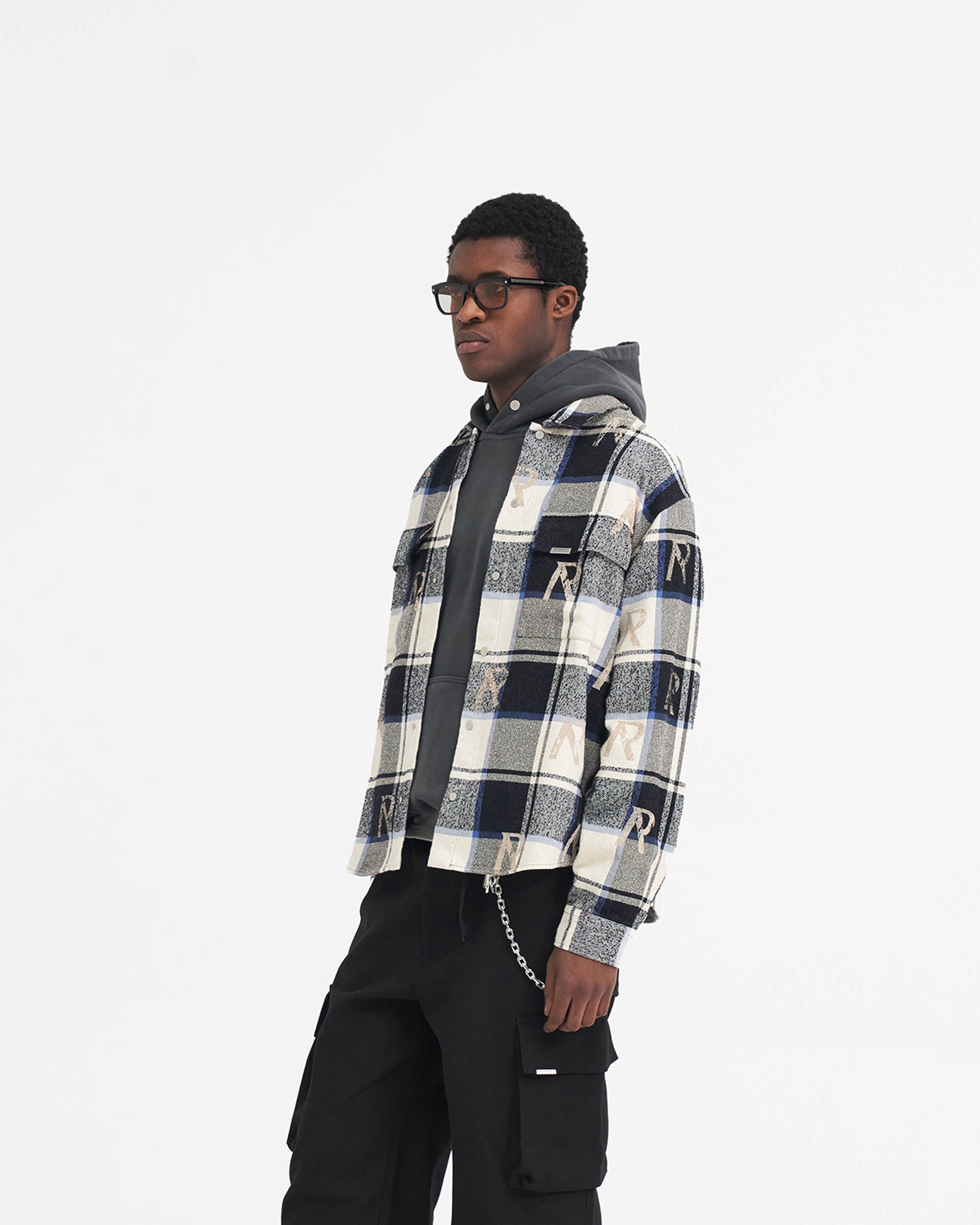 Back product image of a mens blue check flannel shirt on a plain white background | All Over Initial Flannel Shirt in Blue Check | Oversized fit shirt with distressed initial logos and Cobrax popper fastenings | SS24 Shirts | Represent Clo