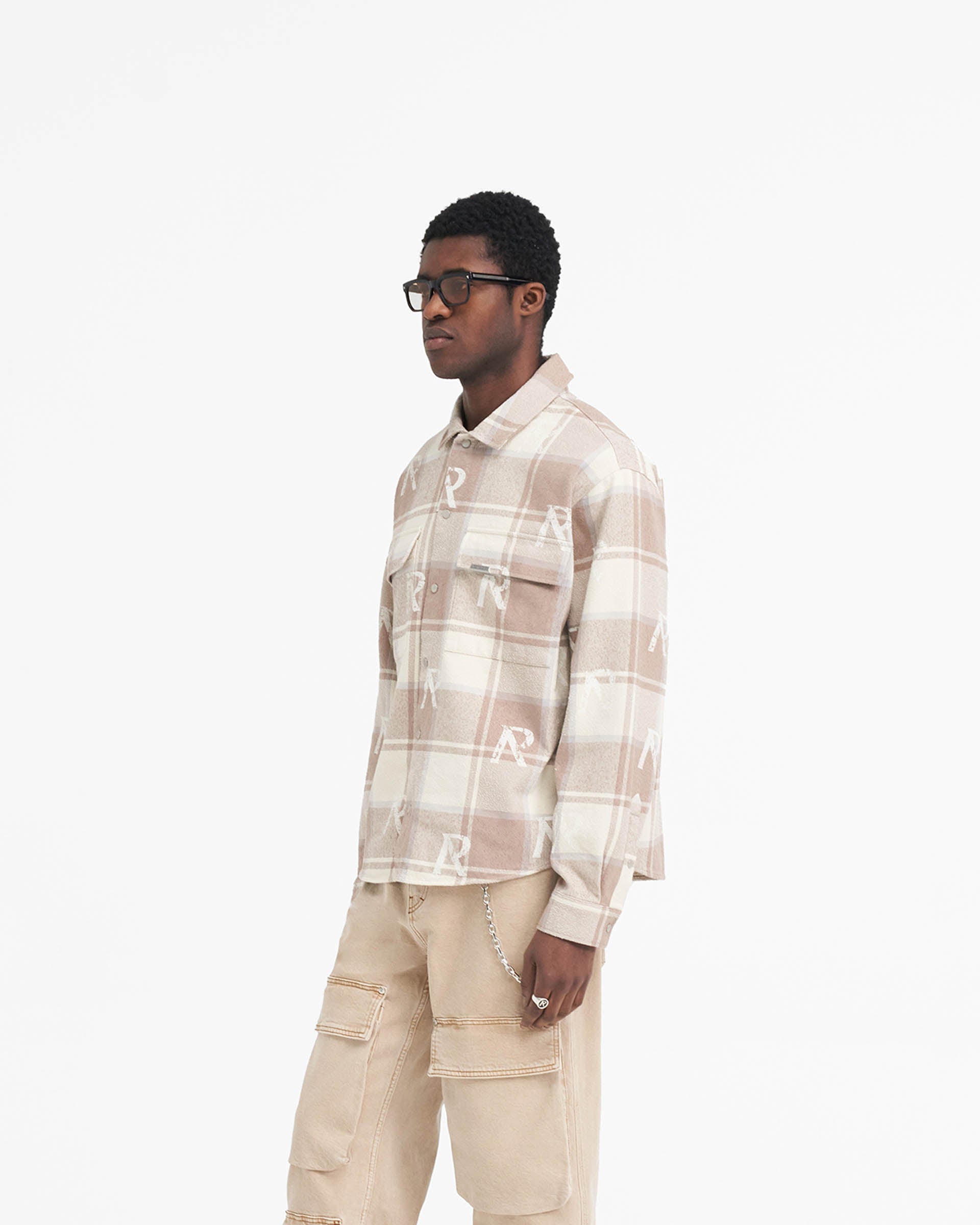Back product image of a mens brown check shirt on a plain white background | All Over Initial Flannel Shirt in Cashmere | Flannel shirt with distressed initial logos and Cobrax popper fastenings | SS24 Shirts | Represent Clo