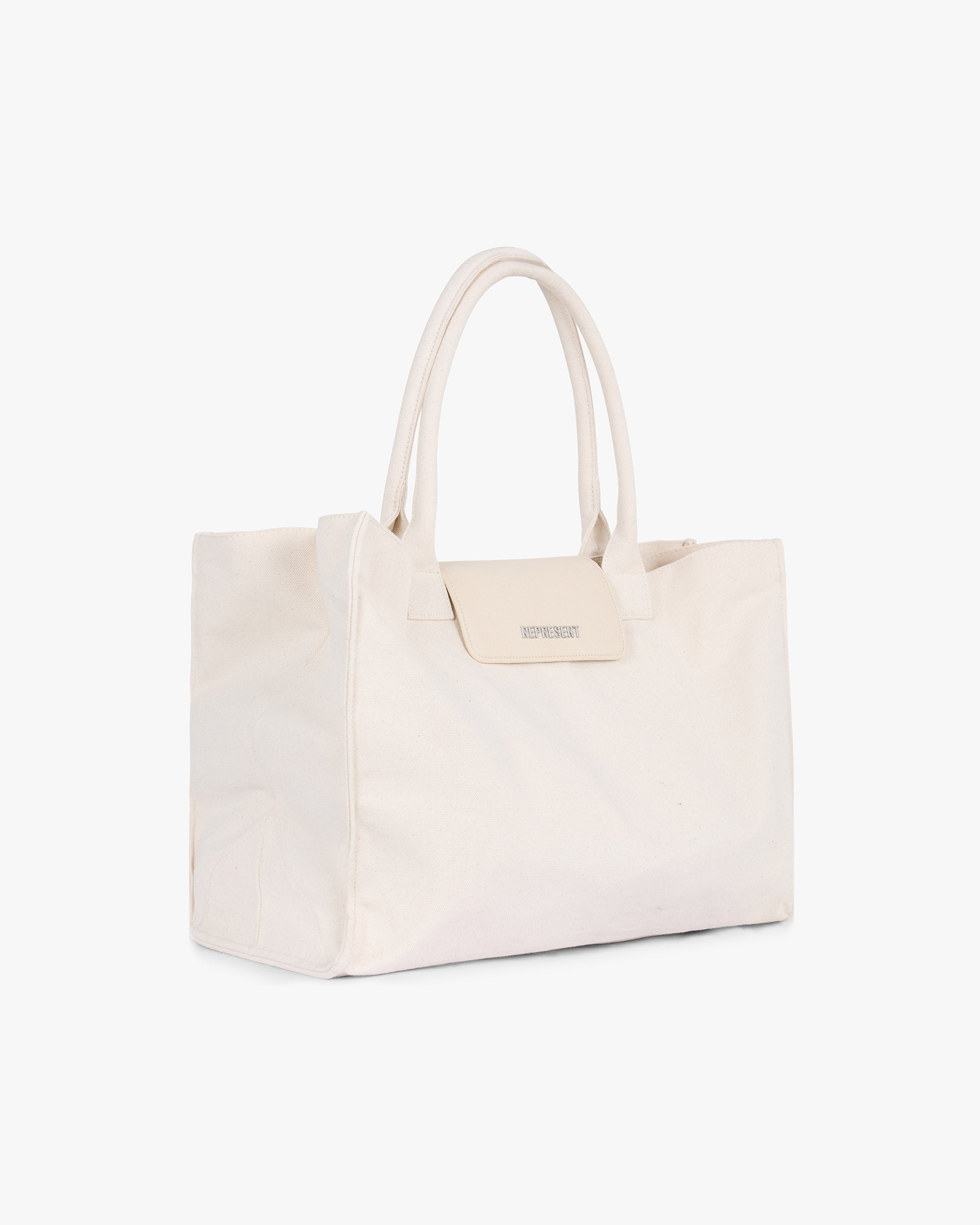 Back product image of a mens white canvas tote bag on a plain white background | Canvas Tote Bag in Antique White | Lightweight canvas tote with spacious compartment | SS25 Accessories | Represent Clo