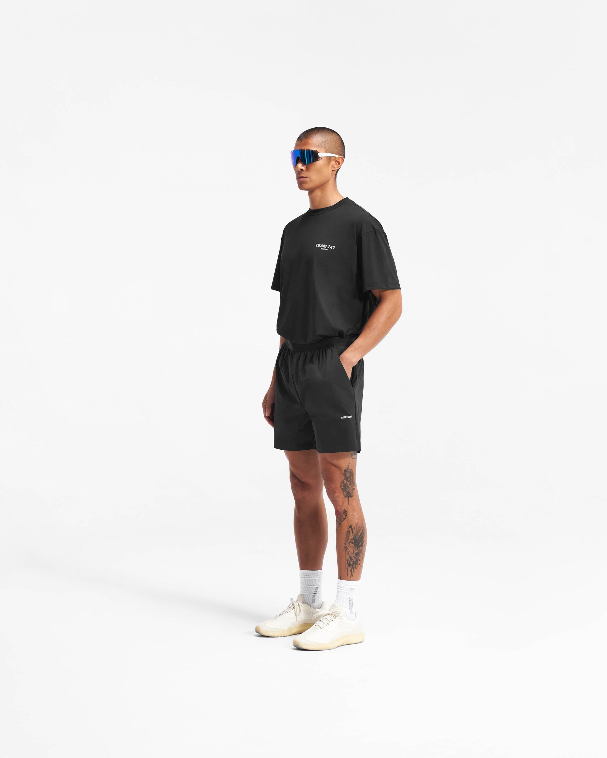Man wearing black gym shorts on a plain white background | Team 247 Fused Shorts in Black | Recycled nylon blend shorts with 4 way stretch | 247 Shorts | Represent Clo