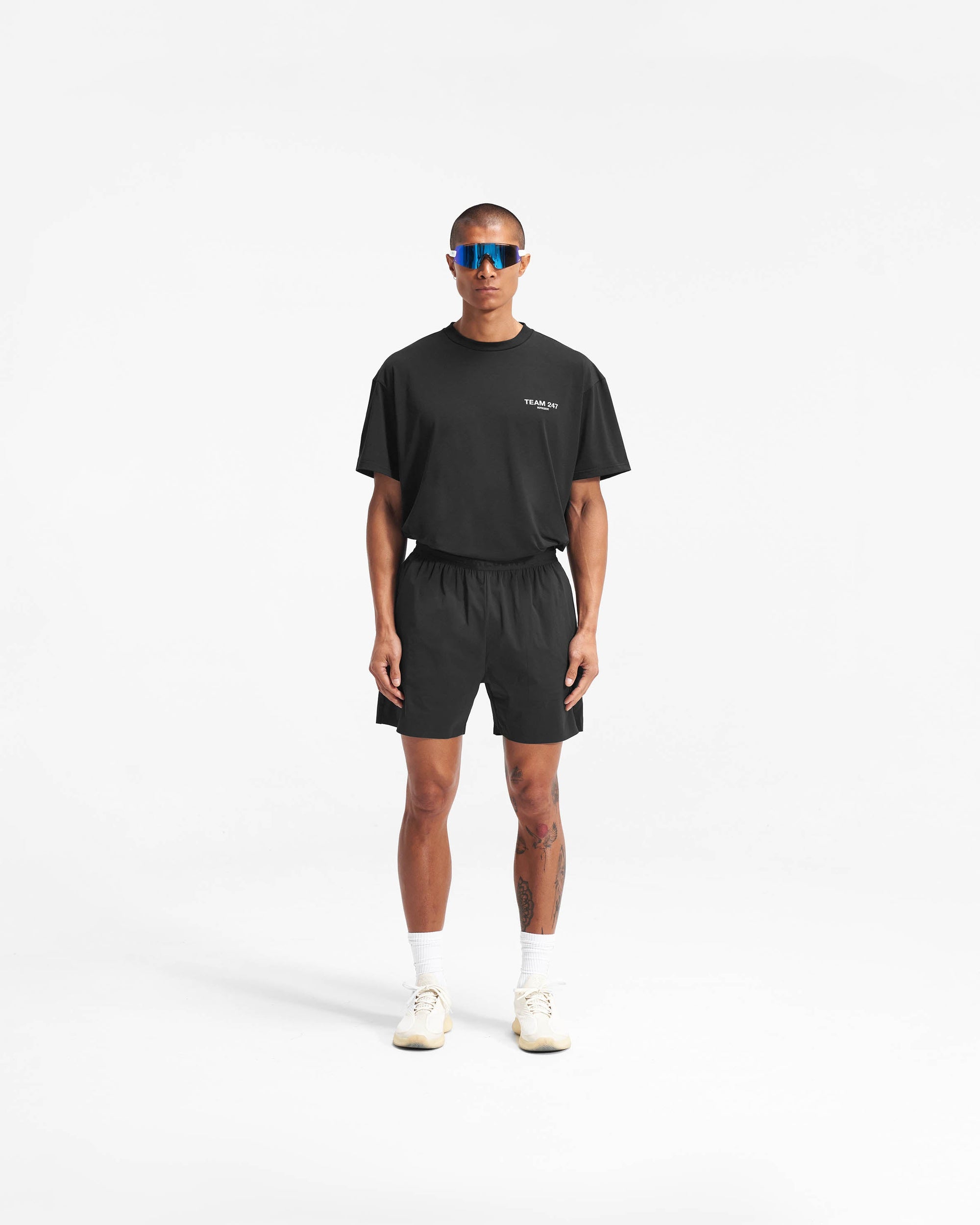 Man wearing black gym shorts on a plain white background | Team 247 Fused Shorts in Black | Recycled nylon blend shorts with quick-drying feature | 247 Shorts | Represent Clo