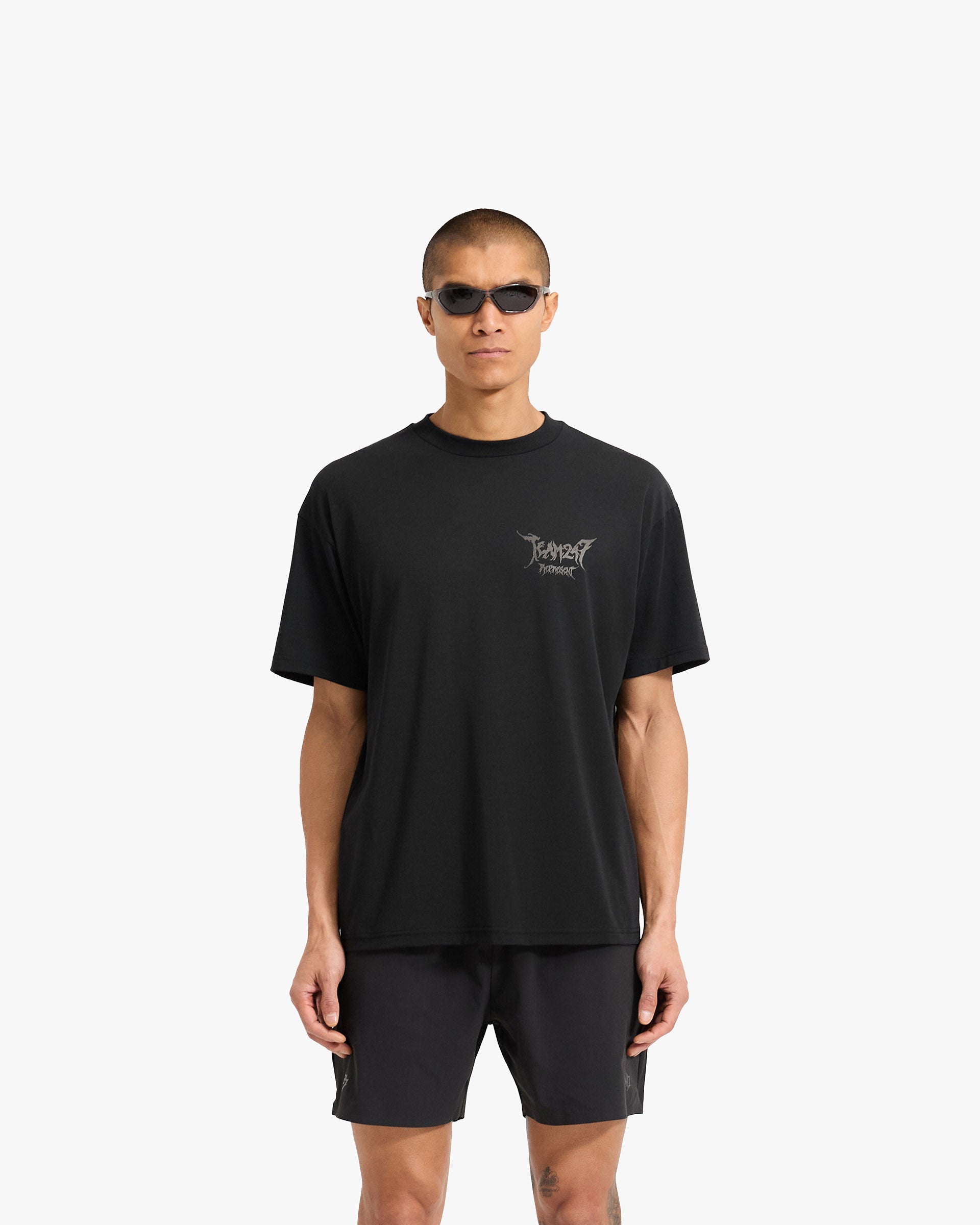 Man wearing an oversized black t-shirt on a plain white background | Team 247 X END Oversized T-Shirt in Jet Black | T-shirts with moisture-wicking Drirelease fabric | 247 T-Shirts | Represent Clo