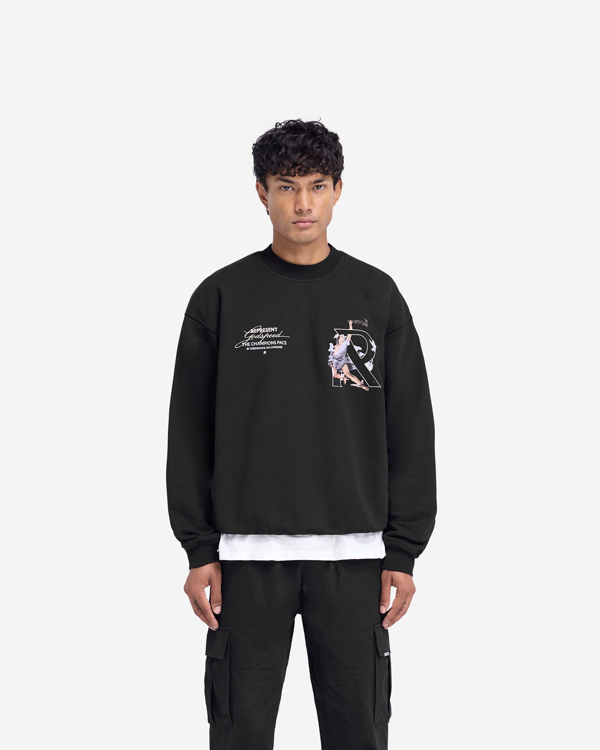 Man wearing a black oversized sweater on a plain white background | Hermes Sweater in Jet Black | Heavy weight jersey with high density graphic | FW24 Sweaters | Represent Clo