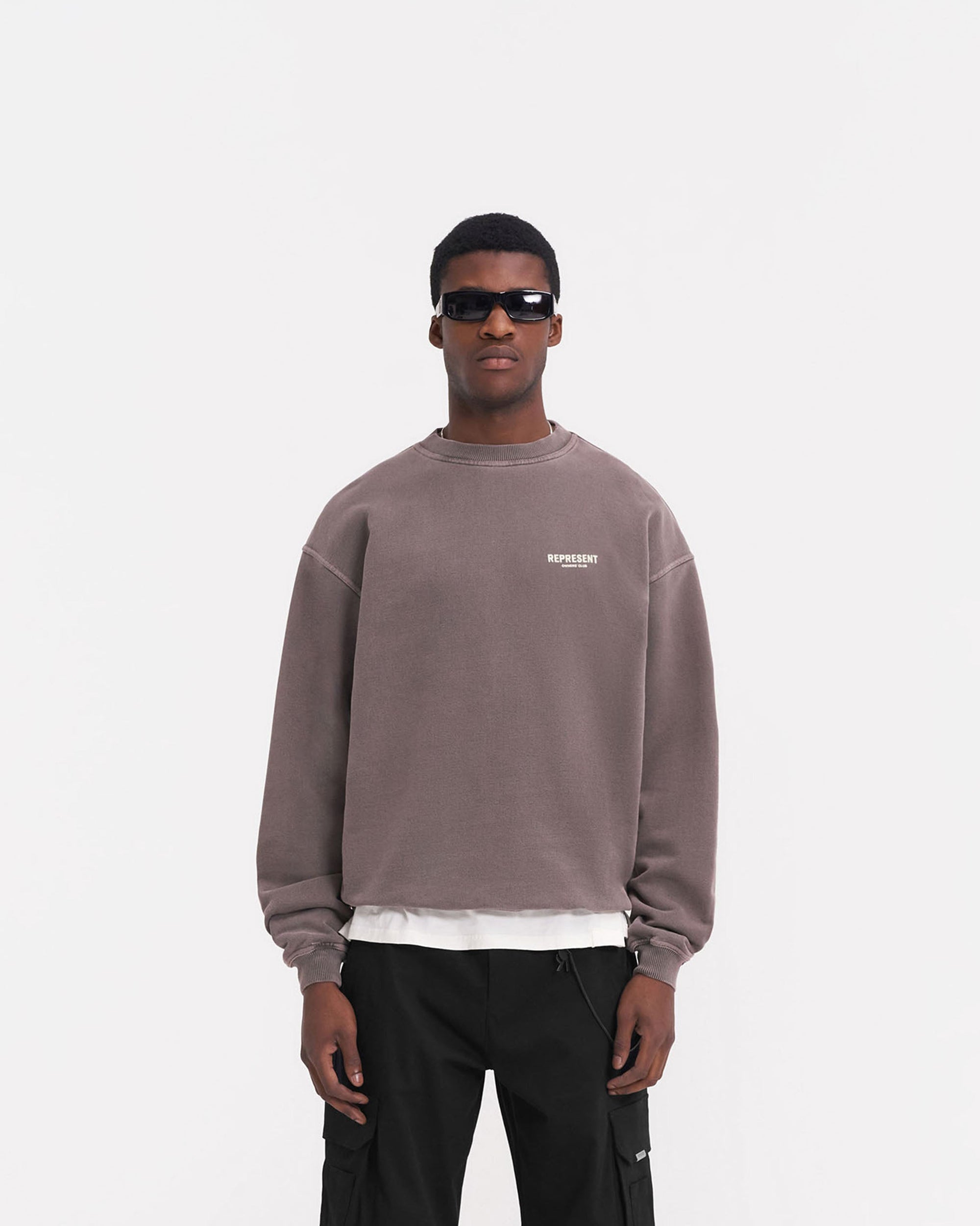Man wearing an oversized grey sweater on a plain white background | Represent Owners Club Sweater in Fog | Heavy weight loopback jersey sweater with ribbed trims | Owners Club Sweaters | Represent Clo