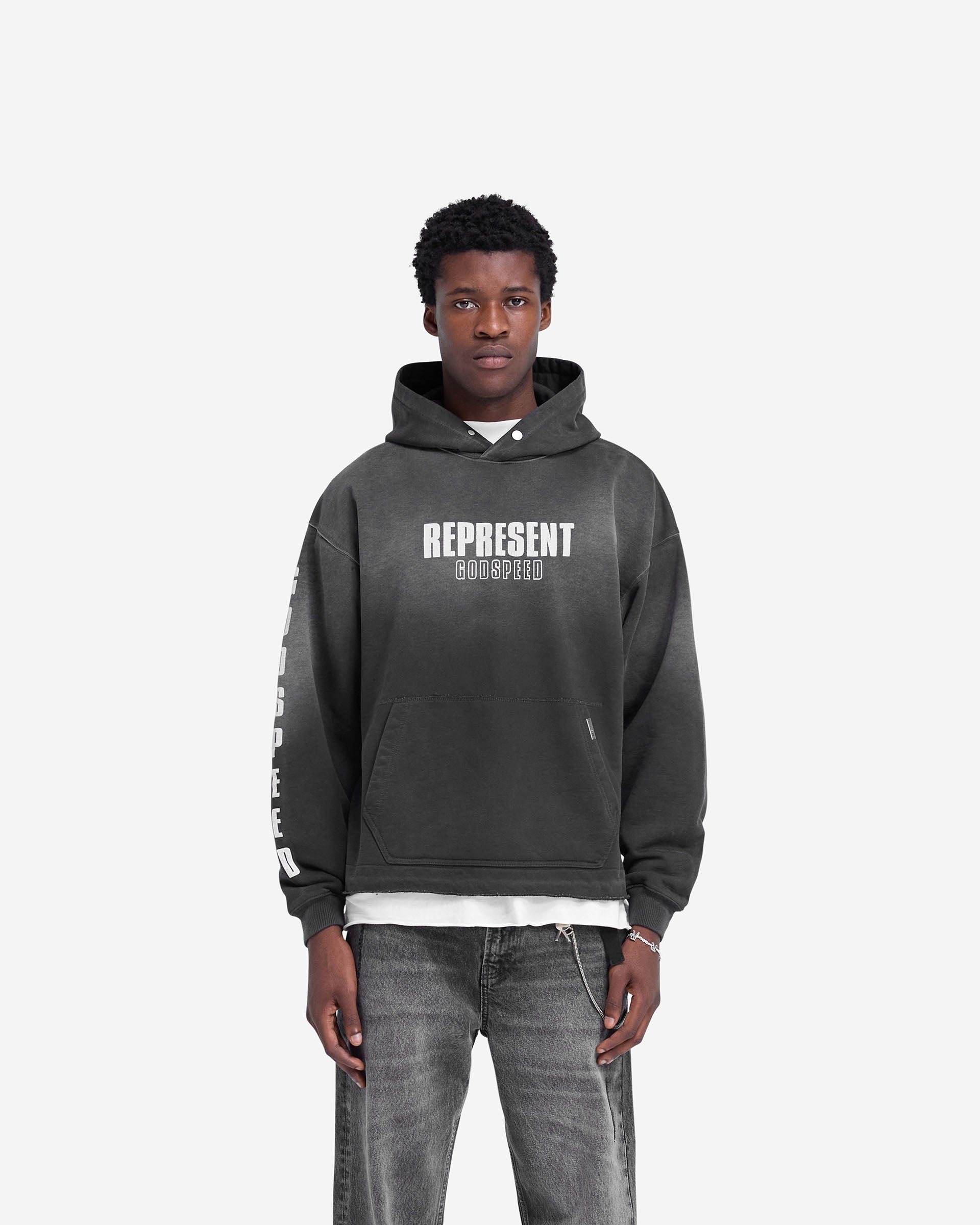 Man wearing a black oversized hoodie on a plain white background | Godspeed Hoodie in Aged Black | Hoodie with cracked graphic and fade out wash | FW24 Hoodies | Represent Clo