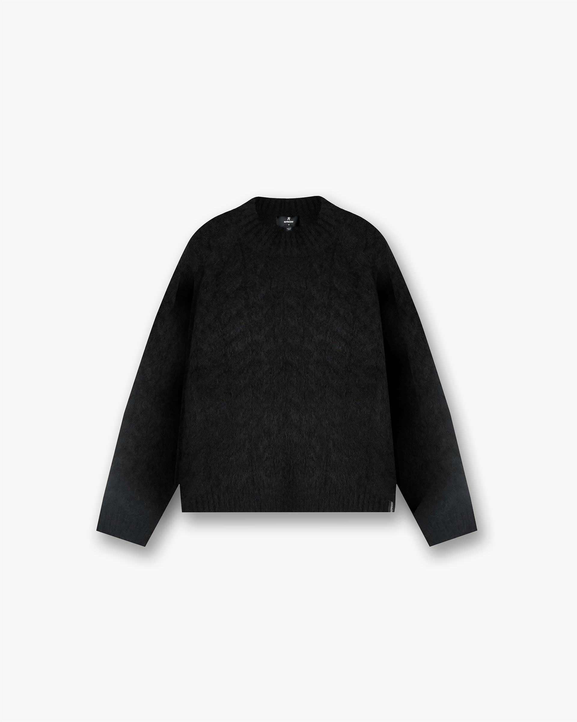 Front product image of a womens black knit sweater on a plain white background | Cable Knit Sweater in Jet Black | Cable knitwear featuring intricate patterns | FW24 Knitwear | Represent Clo