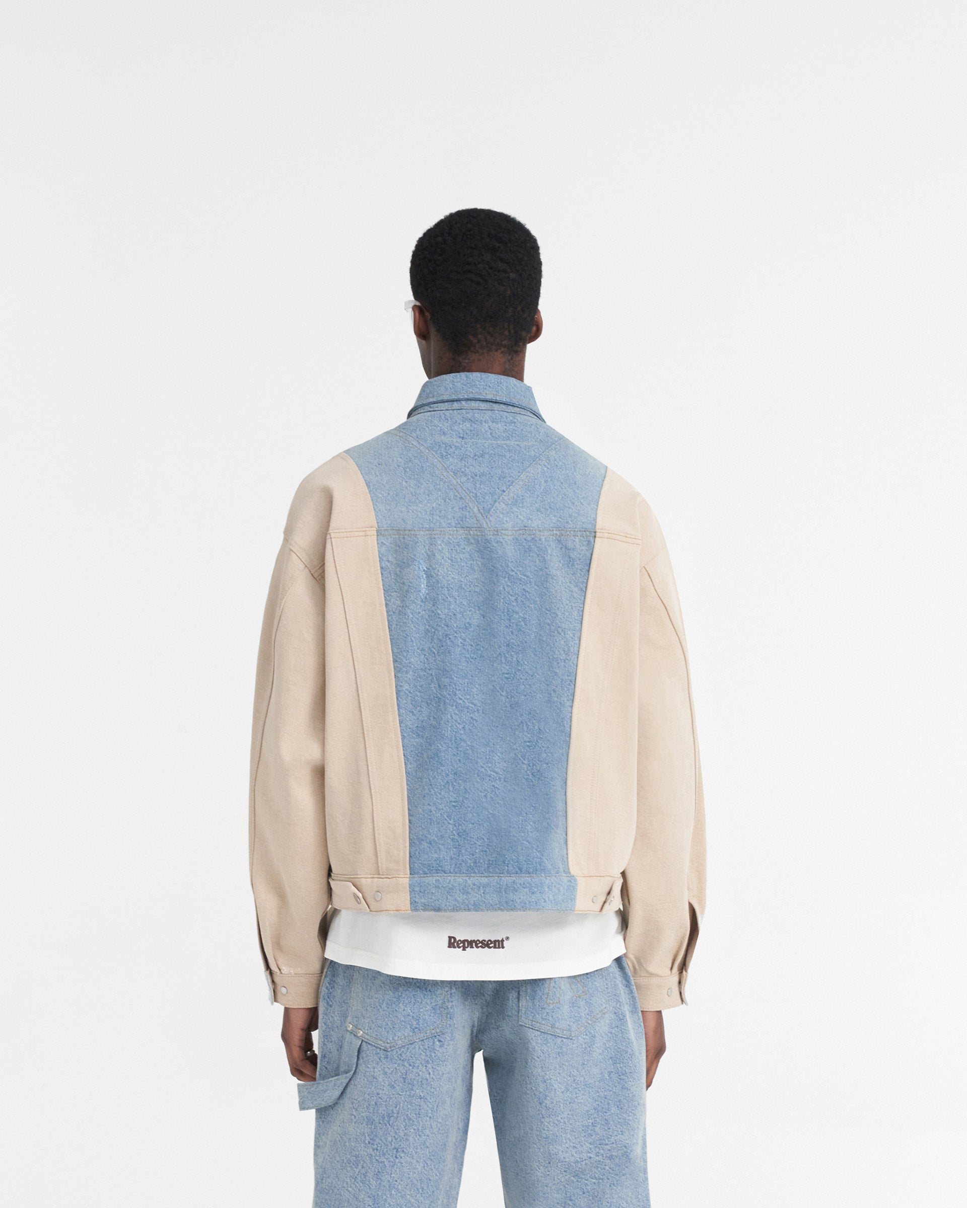 Man wearing a blue denim jacket on a plain white background | R4 Colour Block Denim Jacket in Blue | Boxy fit denim jacket with carpenter panelling | SS24 Denim | Represent Clo