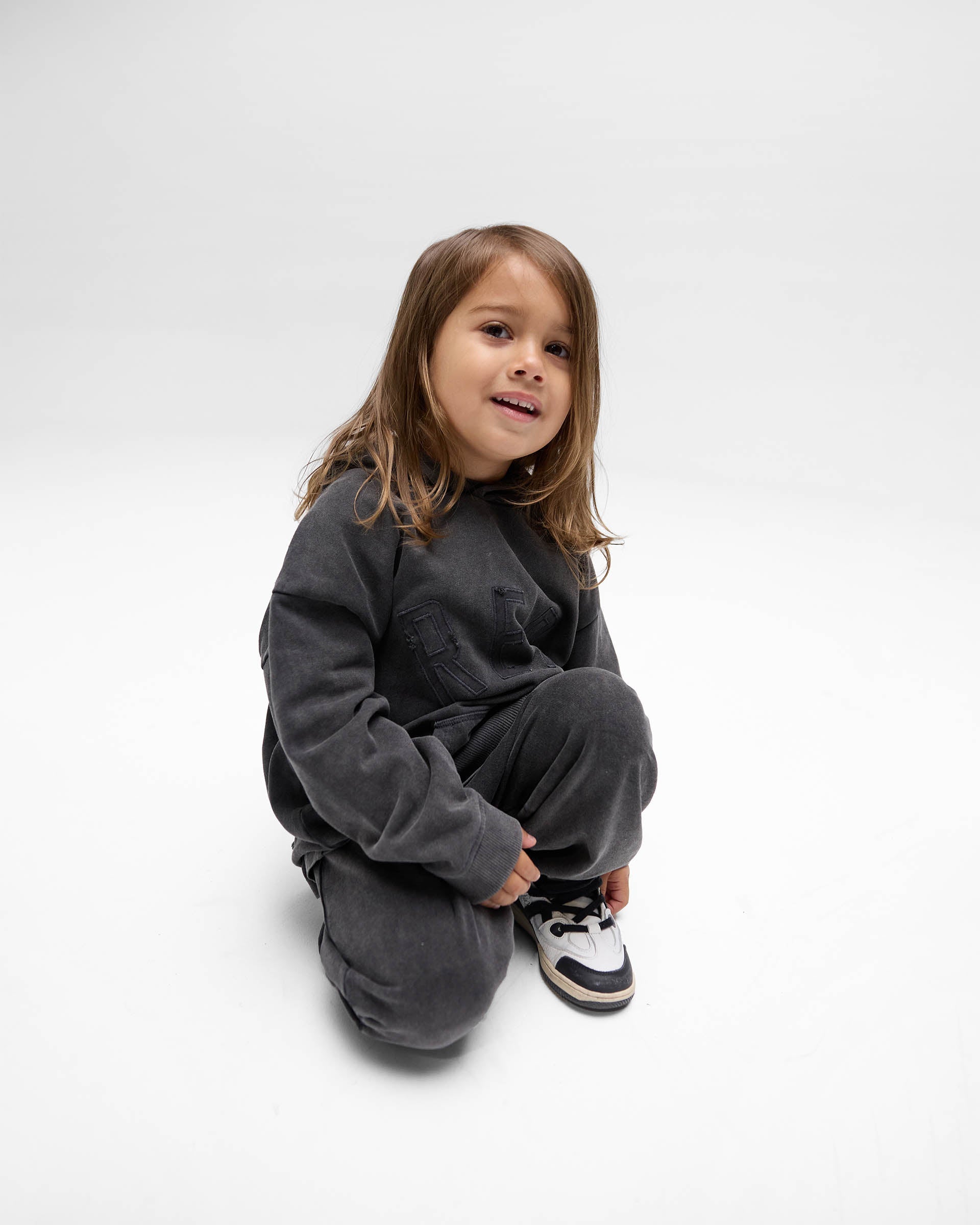 Back product image of a kids black hoodie on a plain white background | Mini Rep Applique Hoodie in Vintage Black | Kids hoodie with oversized fit and applique logo | FW24 Hoodies | Represent Clo