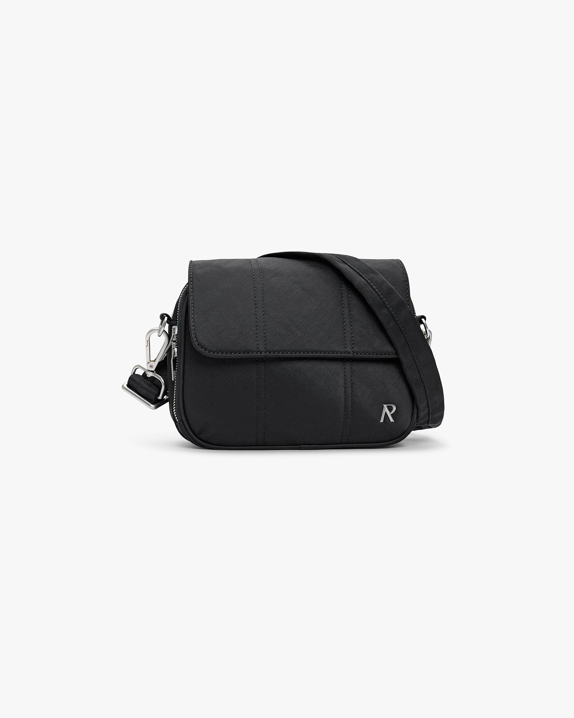 Back product image of a quilted black bag on a plain white background | Quilted Crossbody Bag in Jet Black | Textured nylon crossbody bag | SS25 Accessories | Represent Clo
