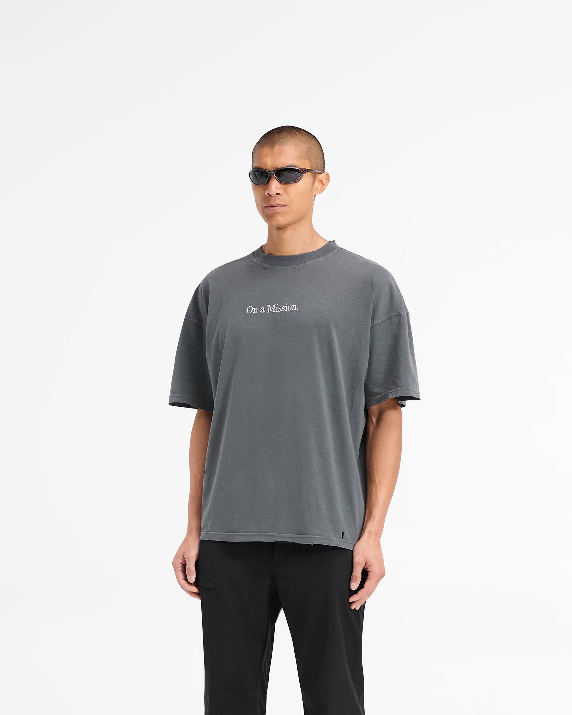 Back product image of a mens aged black t-shirt on a plain white background | 247 On A Mission Oversized T-Shirt in Aged Black | T-shirt with logo embroidery and distressing details | 247 T-Shirts | Represent Clo