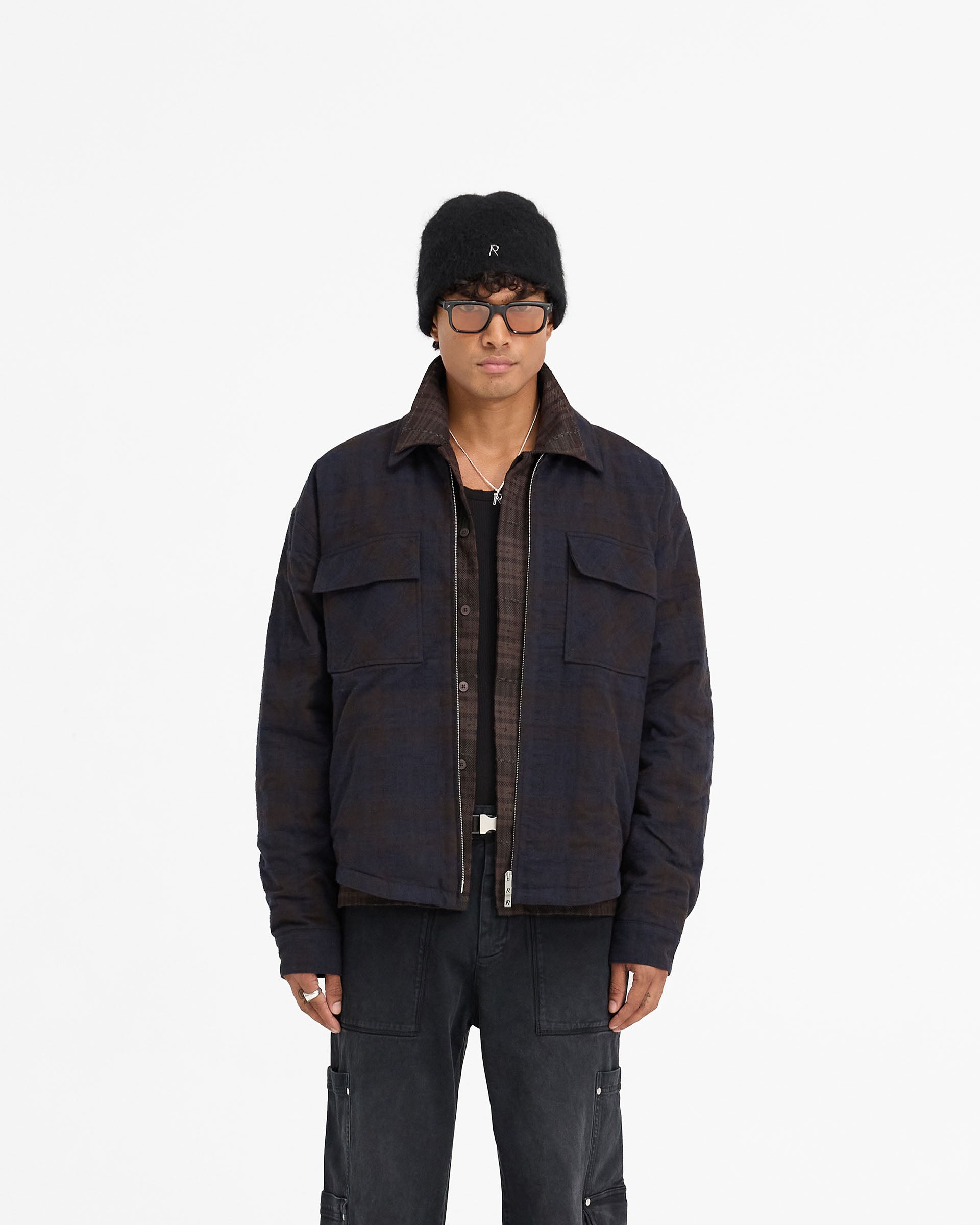 Man wearing a navy overshirt on a plain white background | Wadded Zip Overshirt in Midnight Navy | Luxury wadded overshirt with zip closure and pockets | FW24 Shirts | Represent Clo