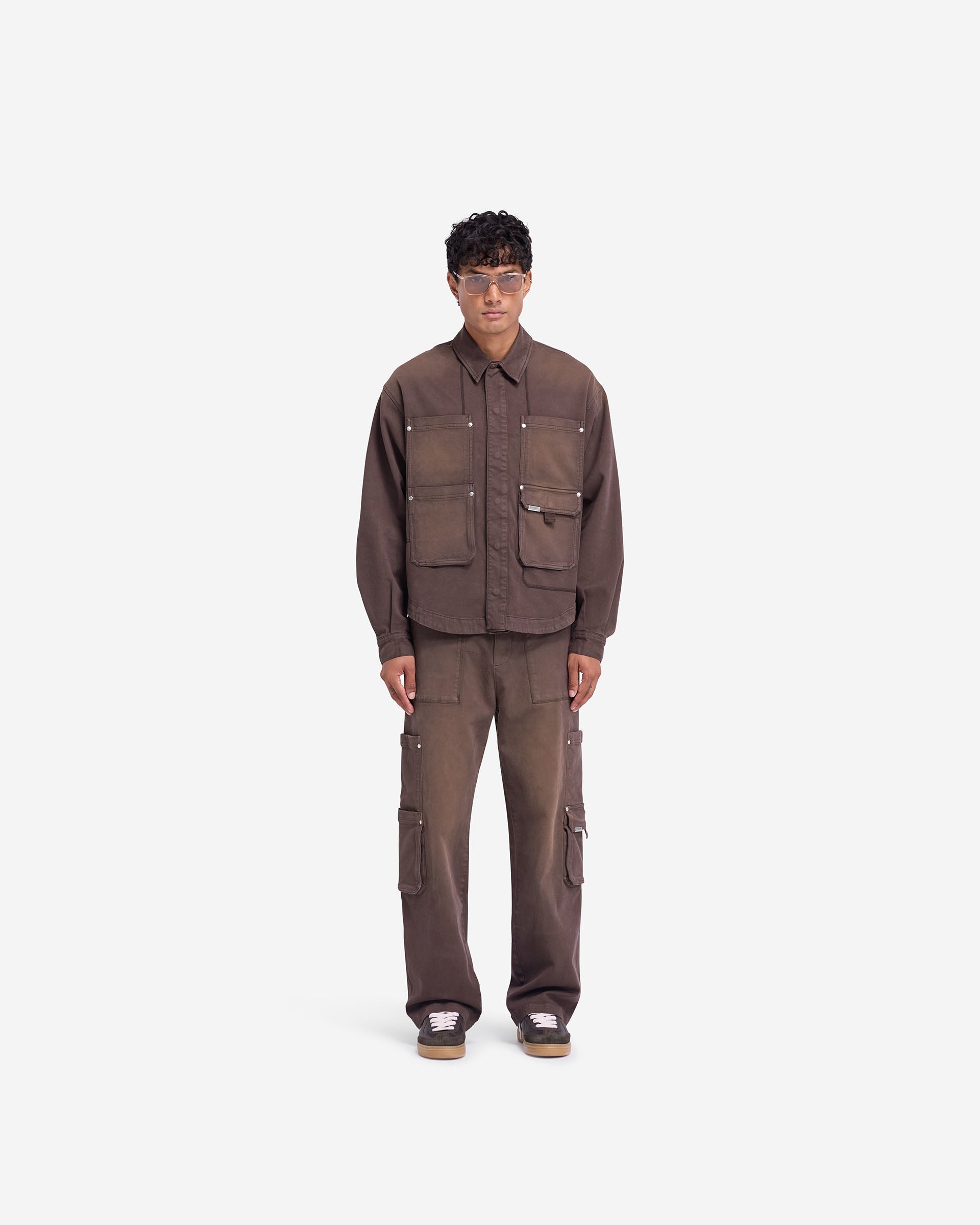 Man wearing cedar pants on a plain white background | Workshop Pant in Cedar | Relaxed straight fit pants with 3D cargo pockets | FW24 Pants | Represent Clo