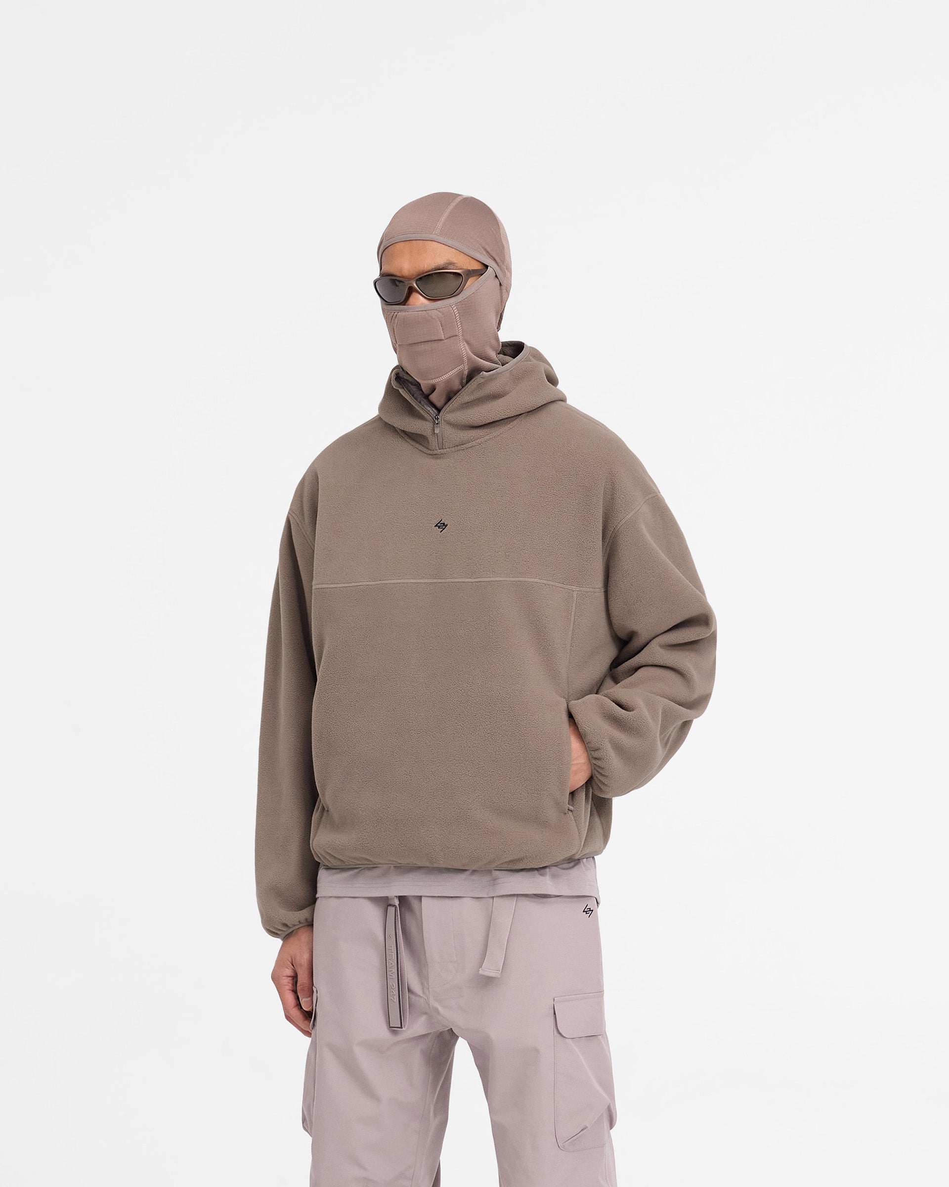 Man wearing an oversized umber fleece hoodie on a plain white background | 247 Fleece Hoodie in Umber | Oversized fleece hoodie with zip pockets | 247 Hoodies | Represent Clo