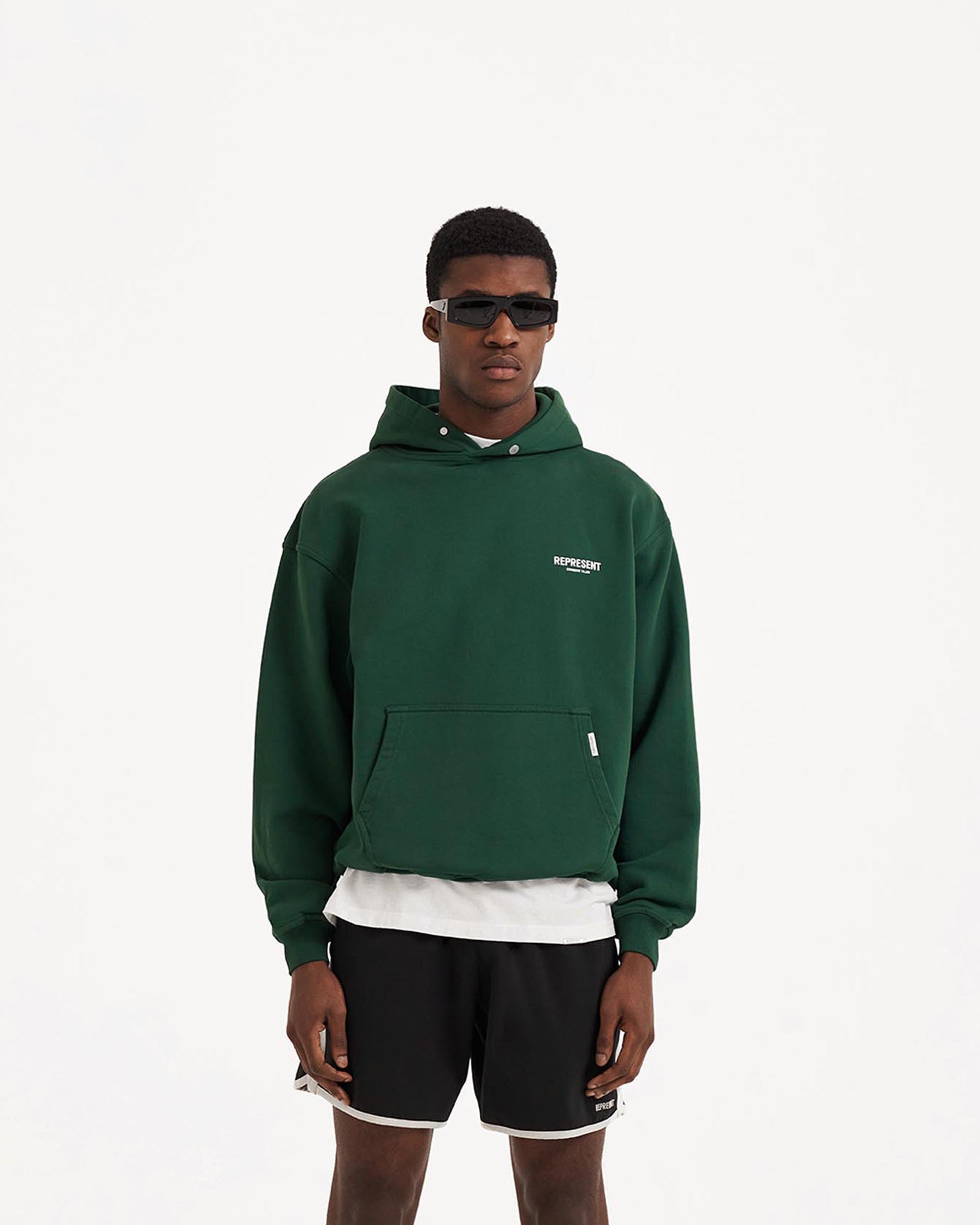 Man wearing an oversized green hoodie on a plain white background | Owners Club Hoodie in Racing Green | Heavy weight jersey cotton hoodie with Cobrax popper | Owners Club Hoodies | Represent Clo