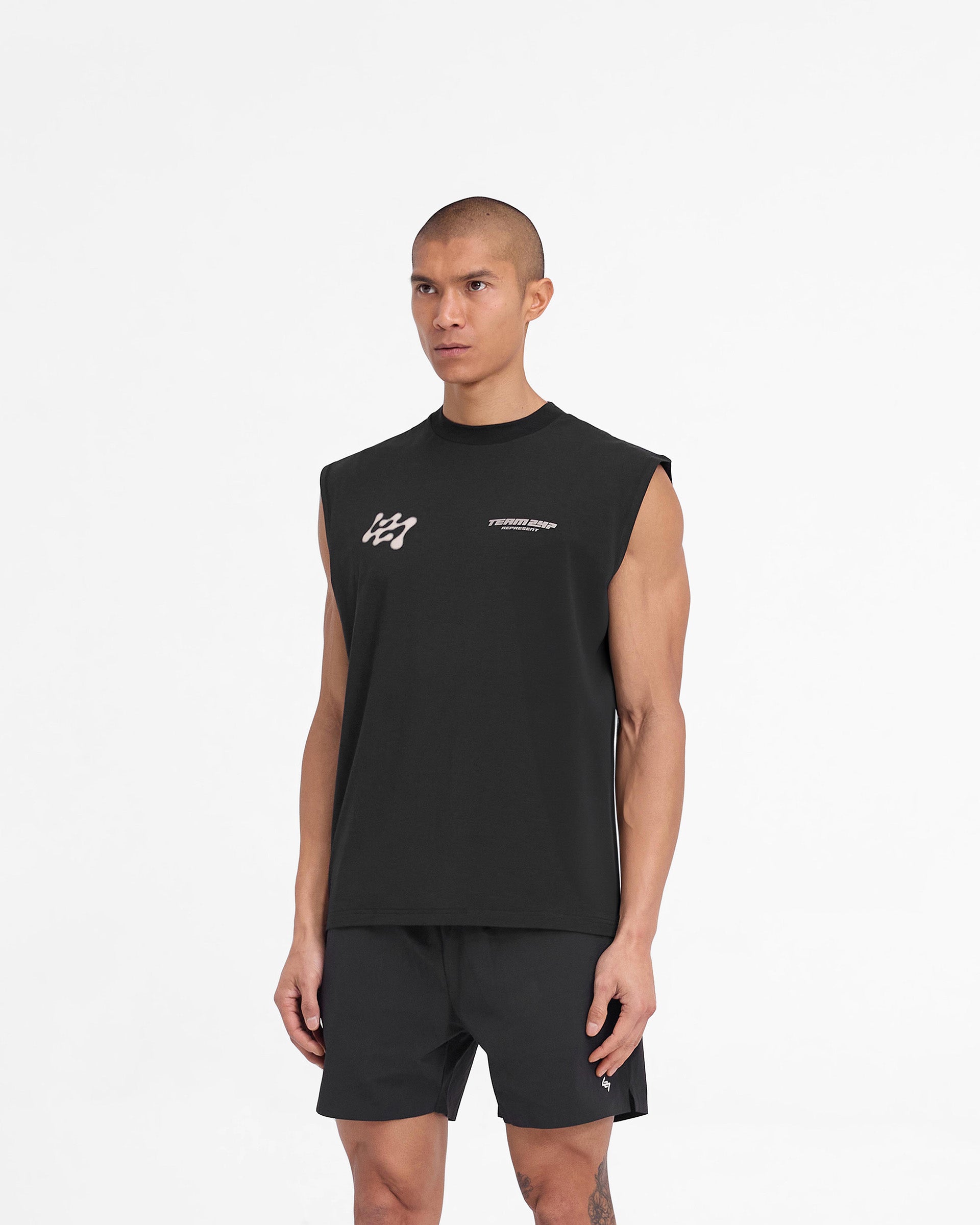 Man wearing a black oversized tank on a plain white background | 247 Future Terrains Oversized Tank in Black | Oversized tank with quick drying and breathable Drirelease fabric | 247 T-Shirts | Represent Clo