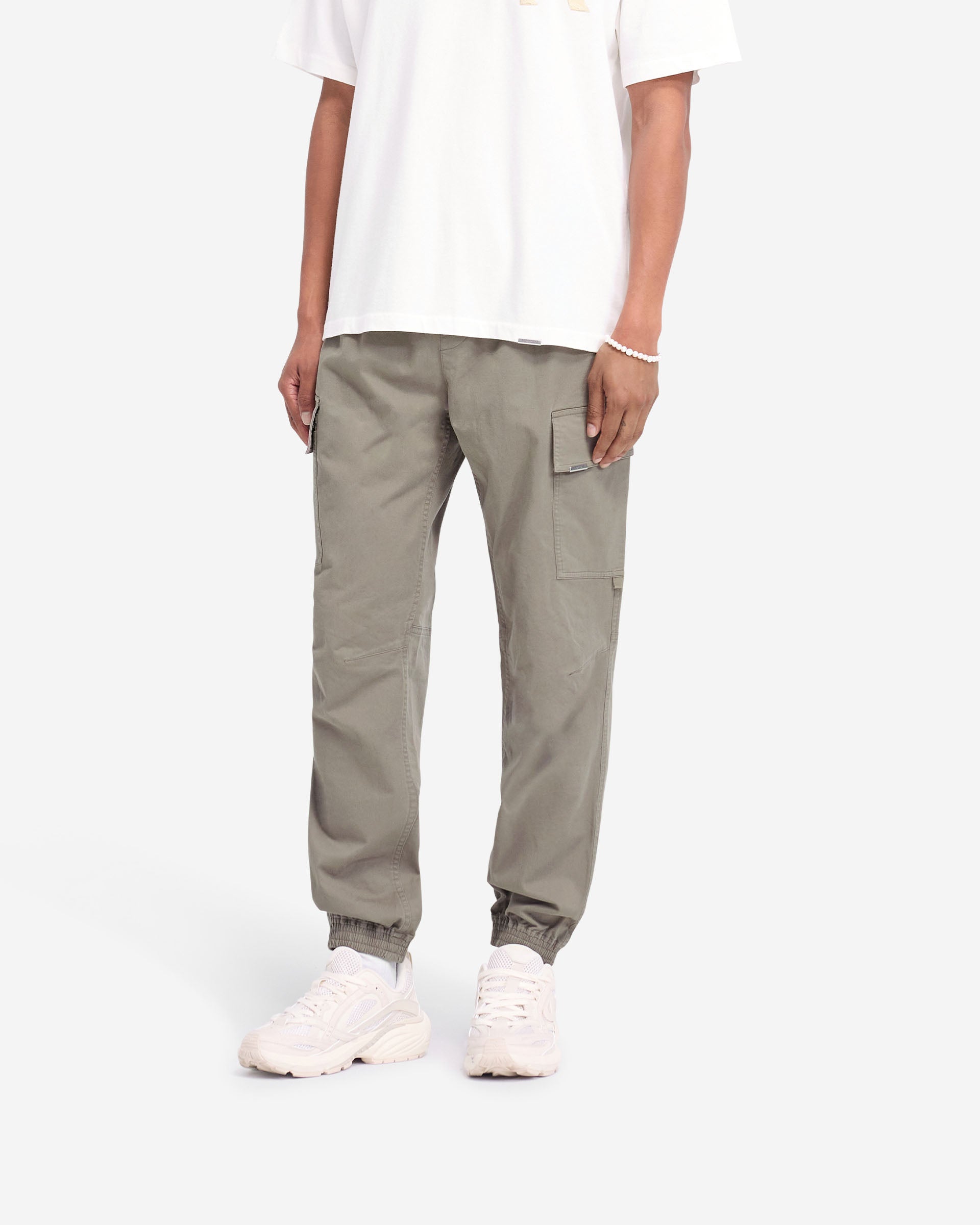 Back product image of mens olive pants on a plain white background | Cuffed Cargo Pant in Olive | Cargo pants with elasticated waistband and cuffs | FW24 Pants | Represent Clo