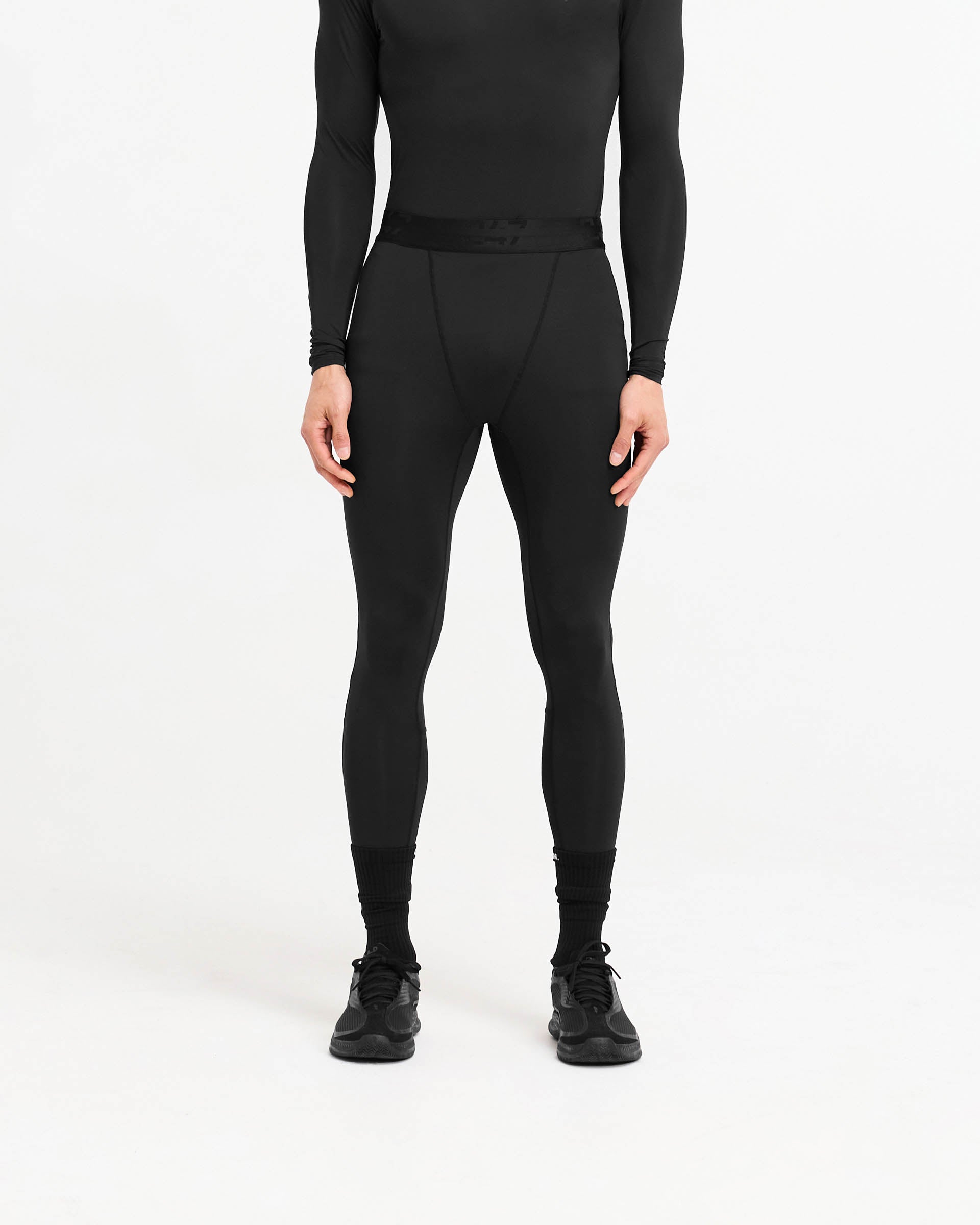 Man wearing black leggings on a plain white background | 247 Compound Legging in Black | Full length leggings with elasticated waistband and fused pocket | 247 Pants | Represent Clo