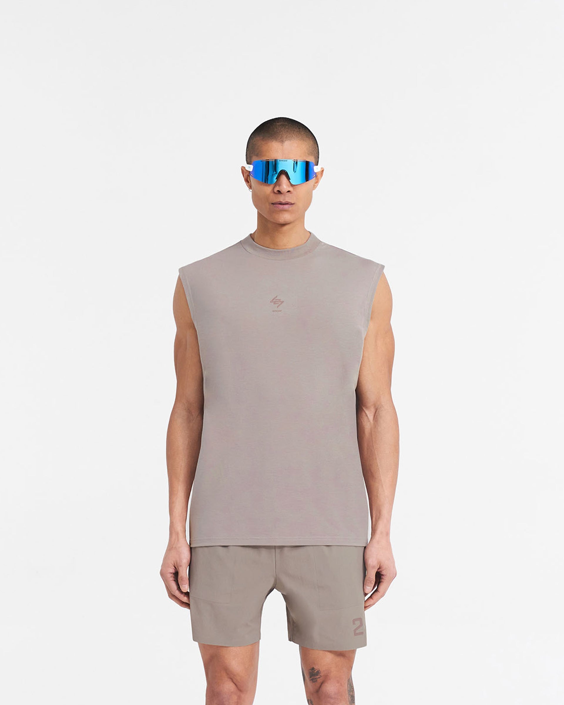 Man wearing a grey oversized tank top on a plain white background | 247 Oversized Tank in Cinder | Lightweight tank top with breathable fabric and 4-way stretch | 247 T-Shirts | Represent Clo