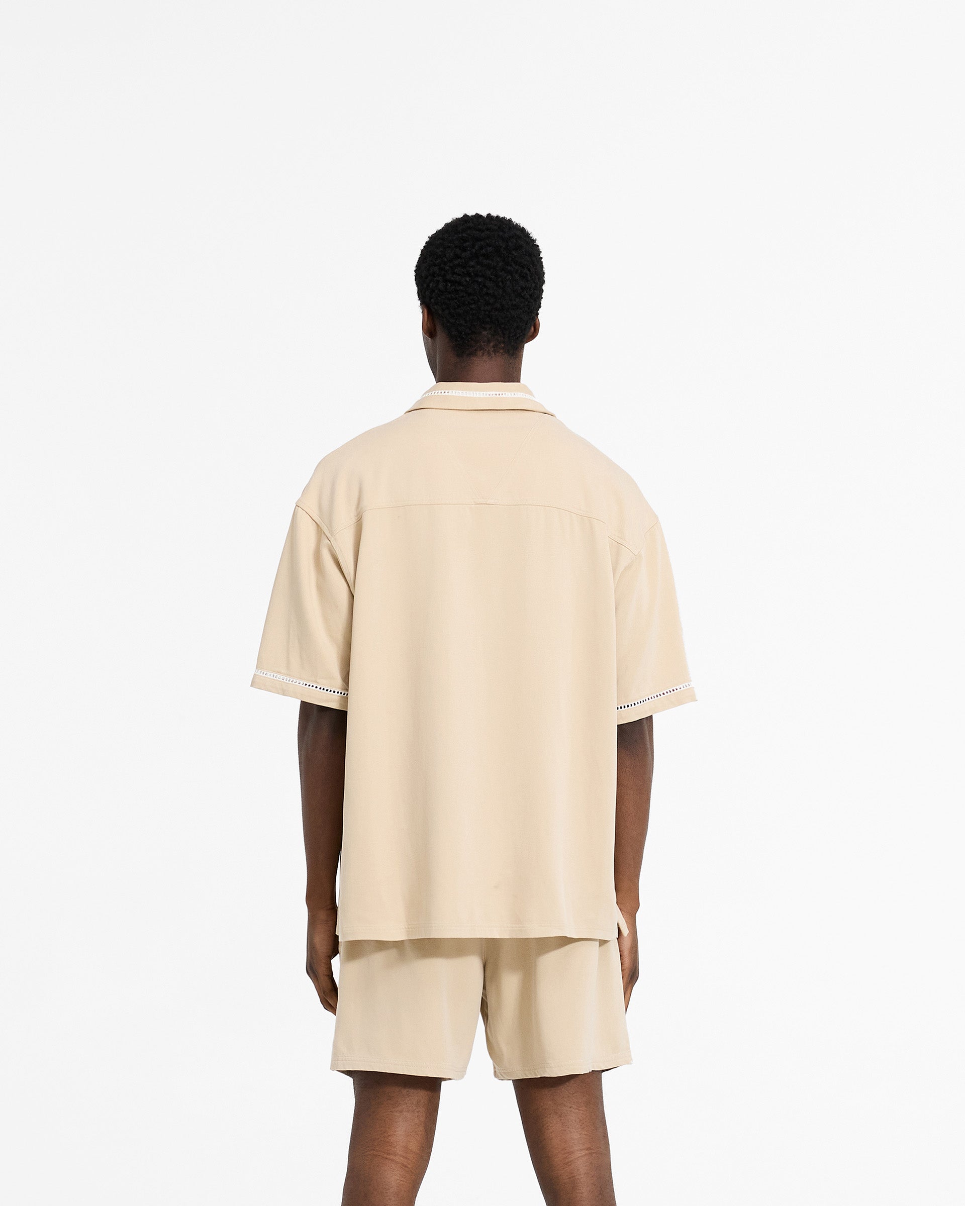 Man wearing a brown shirt on a plain white background | Resort Shirt in Latte | Drapey shirt with revere collar and chest pockets | SC24 Shirts | Represent Clo