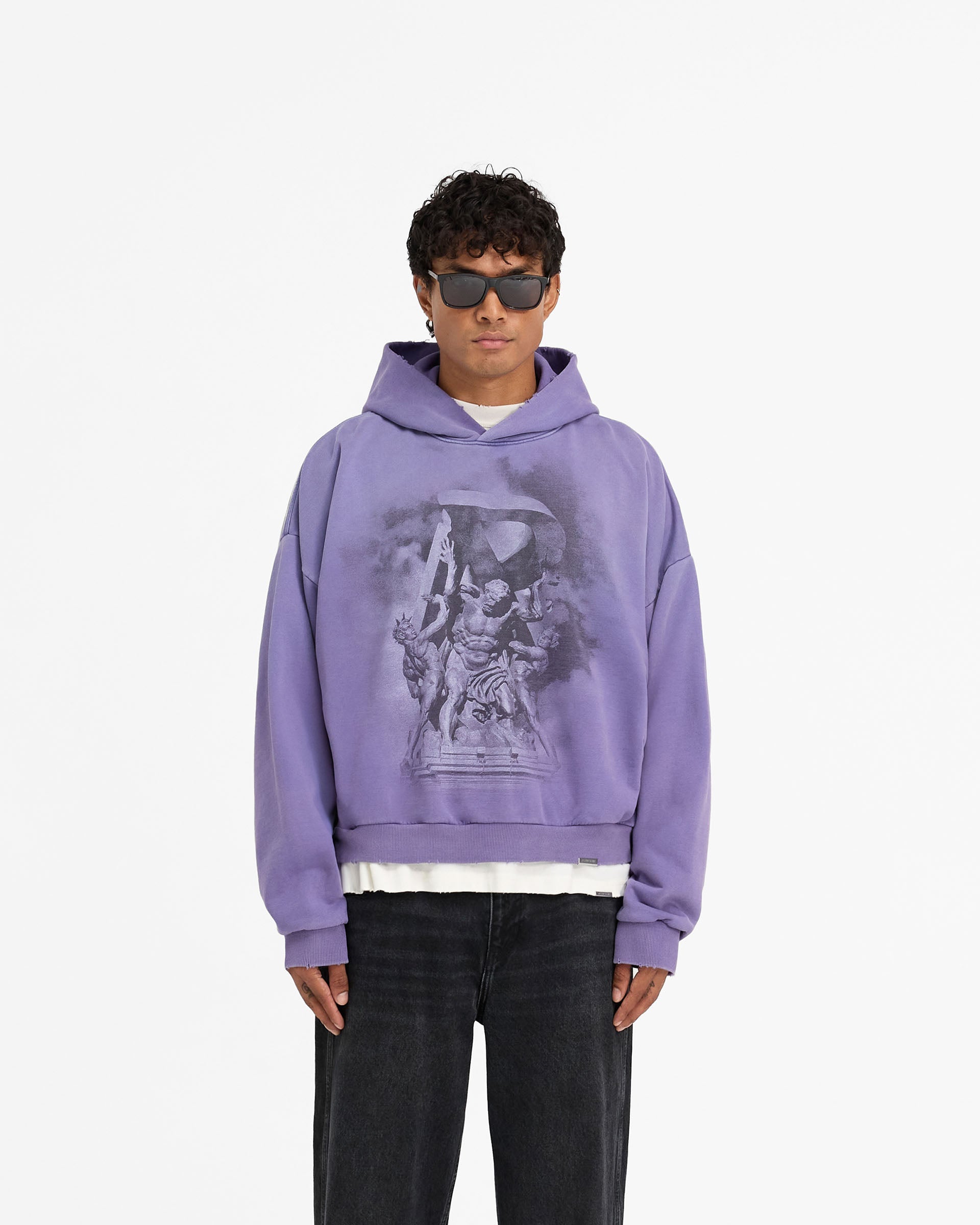 Man wearing an oversized purple hoodie on a plain white background | Atlas Hoodie in Purple | Oversized boxy fit hoodie with puff and screen print graphics | FW24 Hoodies | Represent Clo