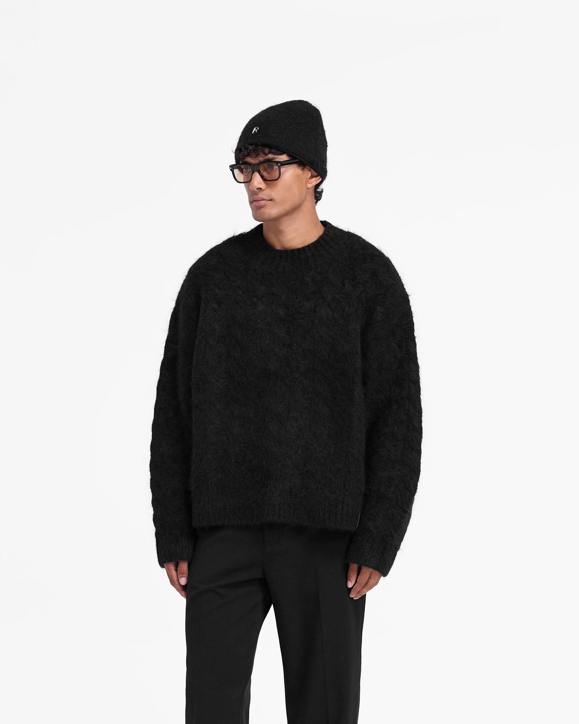 Back product image of a mens black sweater on a plain white background | Cable Knit Sweater in Jet Black | Very oversized knitwear with ribbed hem cuffs and collar | FW24 Knitwear | Represent Clo