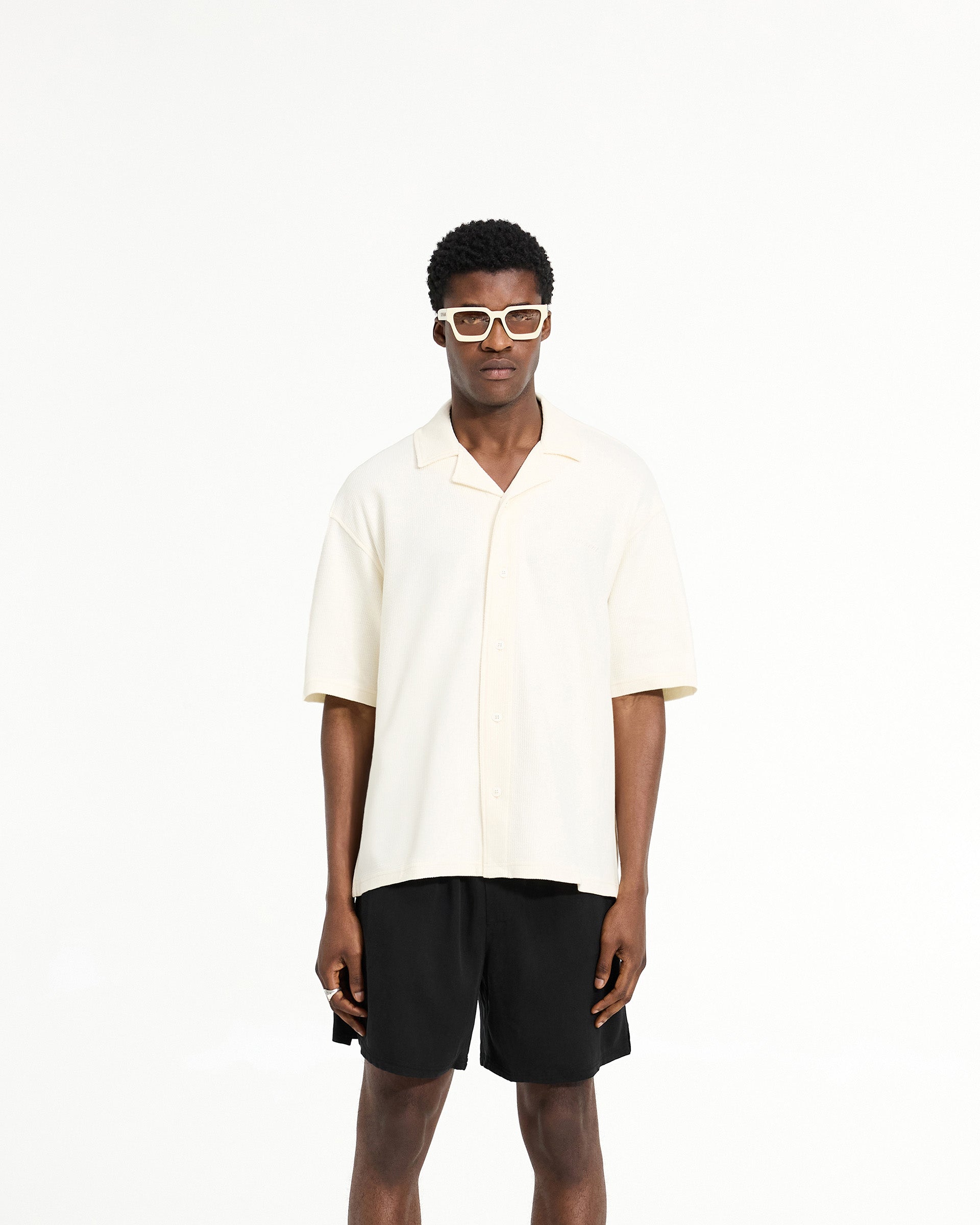 Man wearing a white drapey shirt on a plain white background | Waffle Shirt in Antique White | Drapey fit shirt with revere collar | SC24 Shirts | Represent Clo