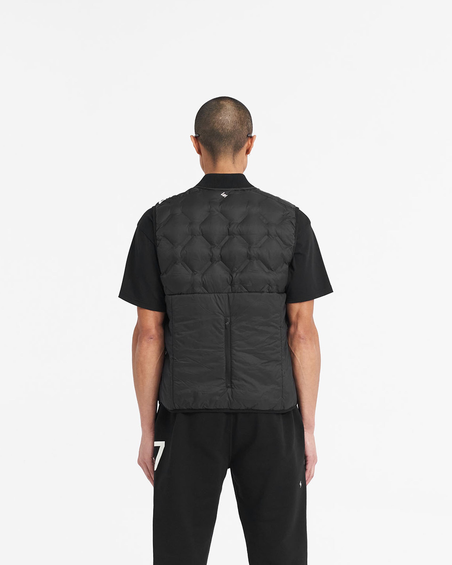 Man wearing a black gilet on a plain white background | 247 Lightweight Gilet in Black | Gilet with feather down fill and bomber collar | 247 Outerwear | Represent Clo