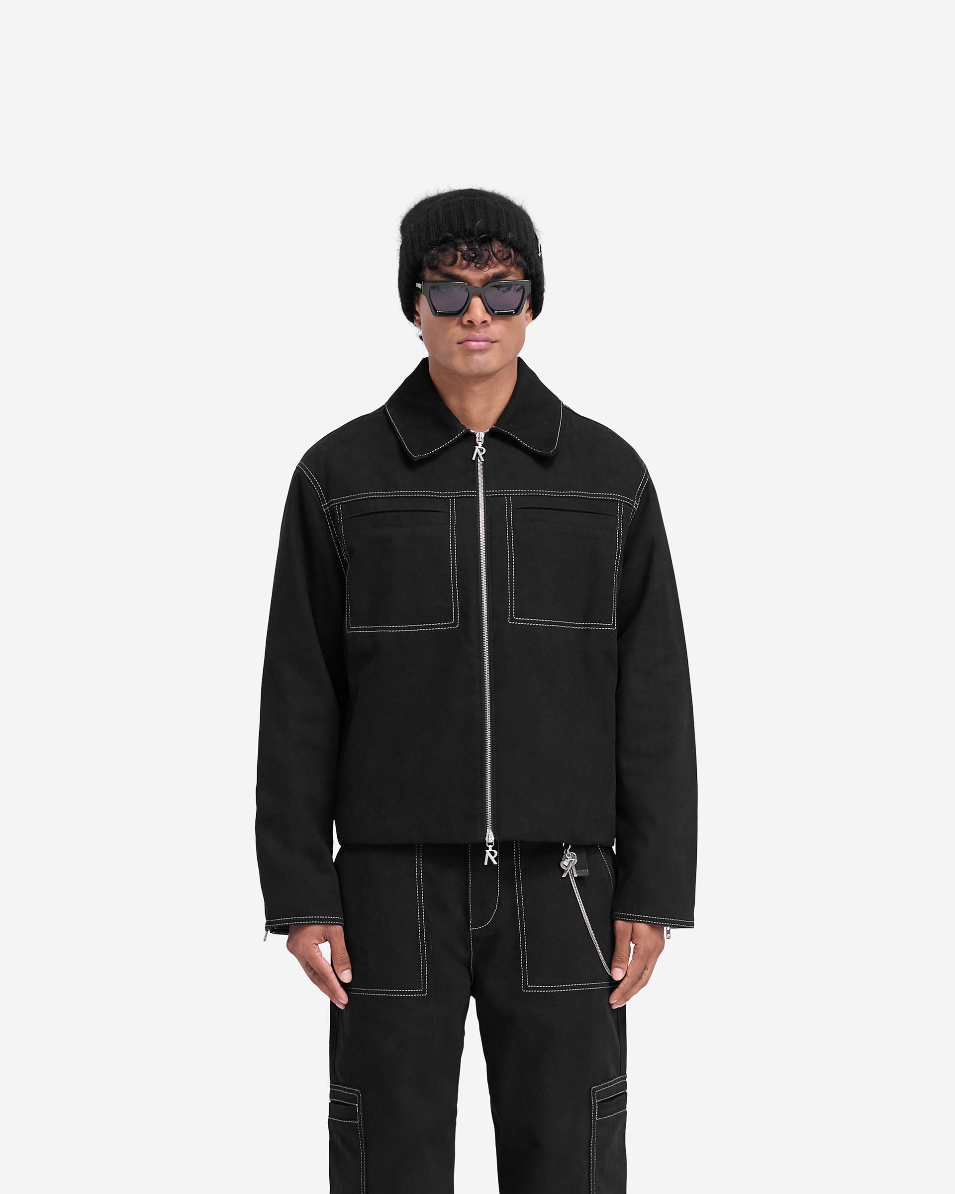Man wearing a black smart jacket on a plain white background | Contrast Stitch Smart Jacket in Jet Black | Oversized jacket with contrast stitching | FW24 Outerwear | Represent Clo