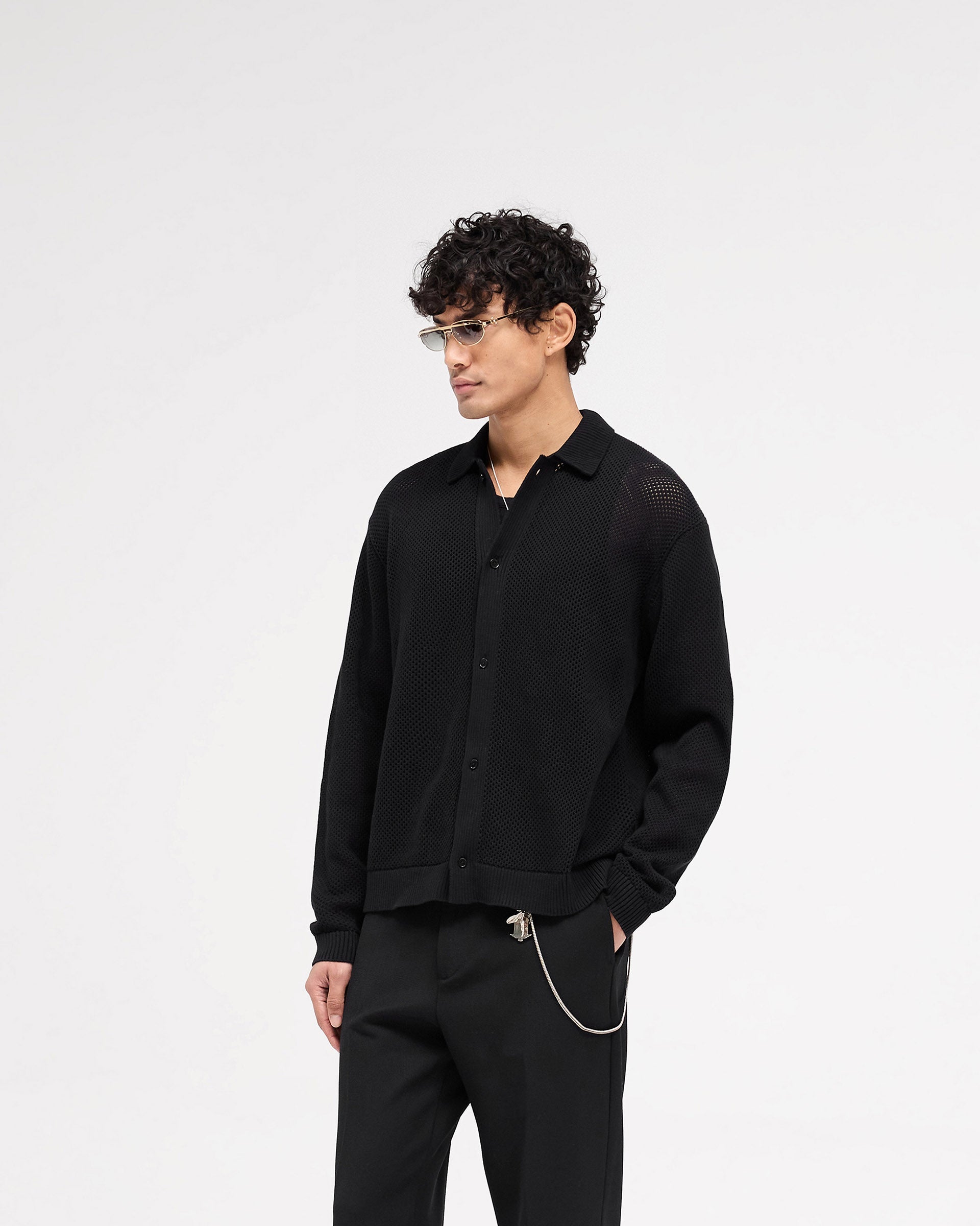 Back product image of a mens black mesh knit shirt on a plain white background | Long Sleeve Mesh Knit Shirt in Jet Black | Button up oversized fit knitwear | SS25 Knitwear | Represent Clo