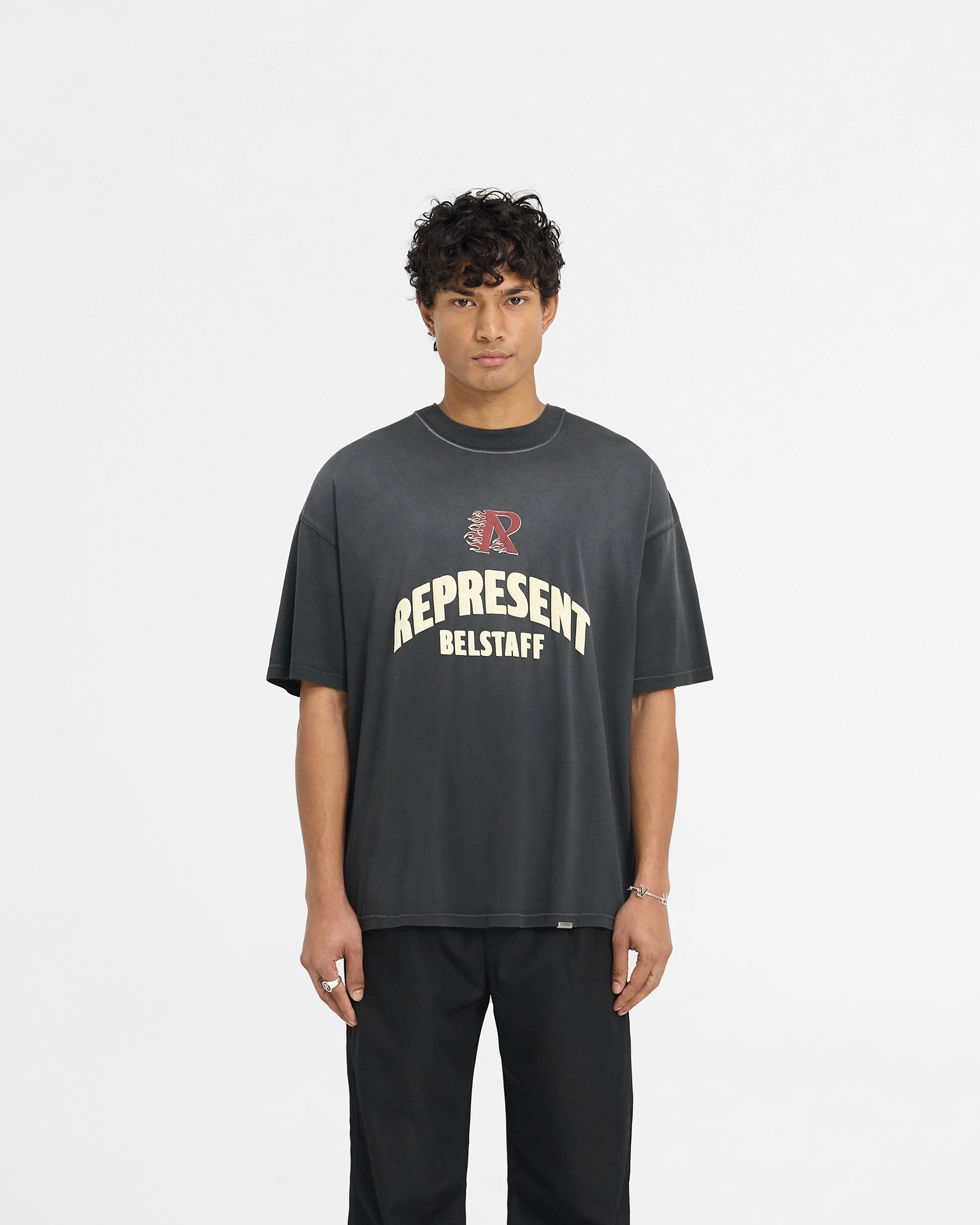 Man wearing a black t-shirt on a plain white background | Represent X Belstaff Flame Phoenix T-Shirt in Shadow | Oversized medium weight t-shirt with stylised prints | Exclusives T-Shirts | Represent Clo