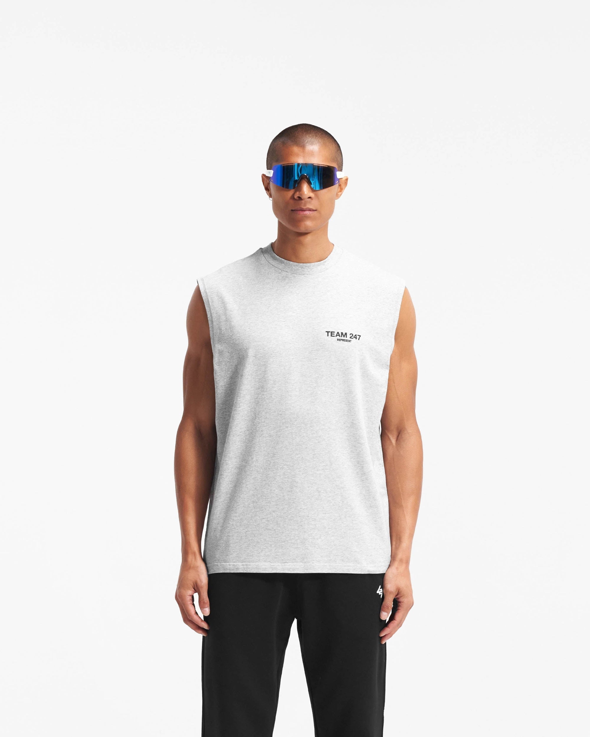 Man wearing an oversized grey tank top on a plain white background | Team 247 Oversized Tank in Ash Grey | Lightweight breathable tank with 4-way stretch | 247 T-Shirts | Represent Clo