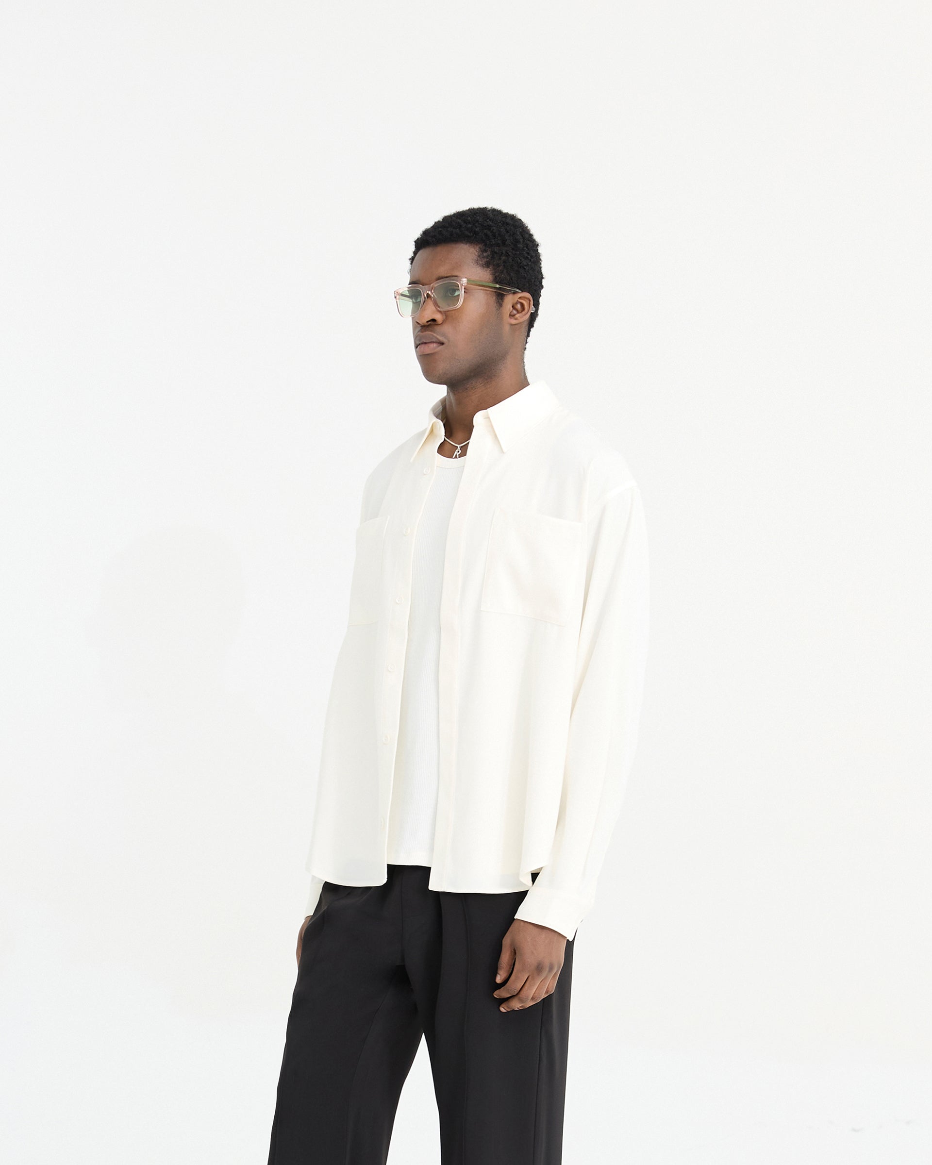Man wearing a white shirt on a plain white background | Initial Shirt in Flat White | Shirt with chest pockets and concealed placket | Initial Shirts | Represent Clo