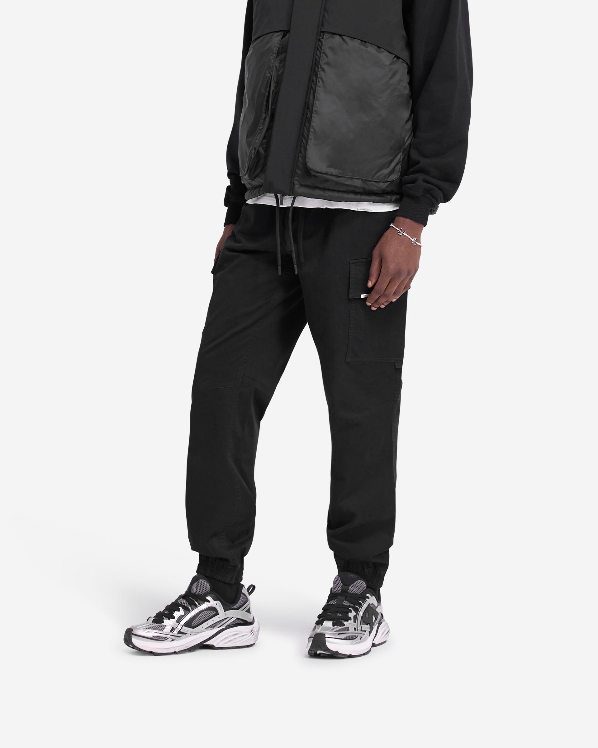 Back product image of mens black cargo pants on a plain white background | Cuffed Cargo Pant in Black | Pants with elasticated waistband and cuffs | FW24 Pants | Represent Clo