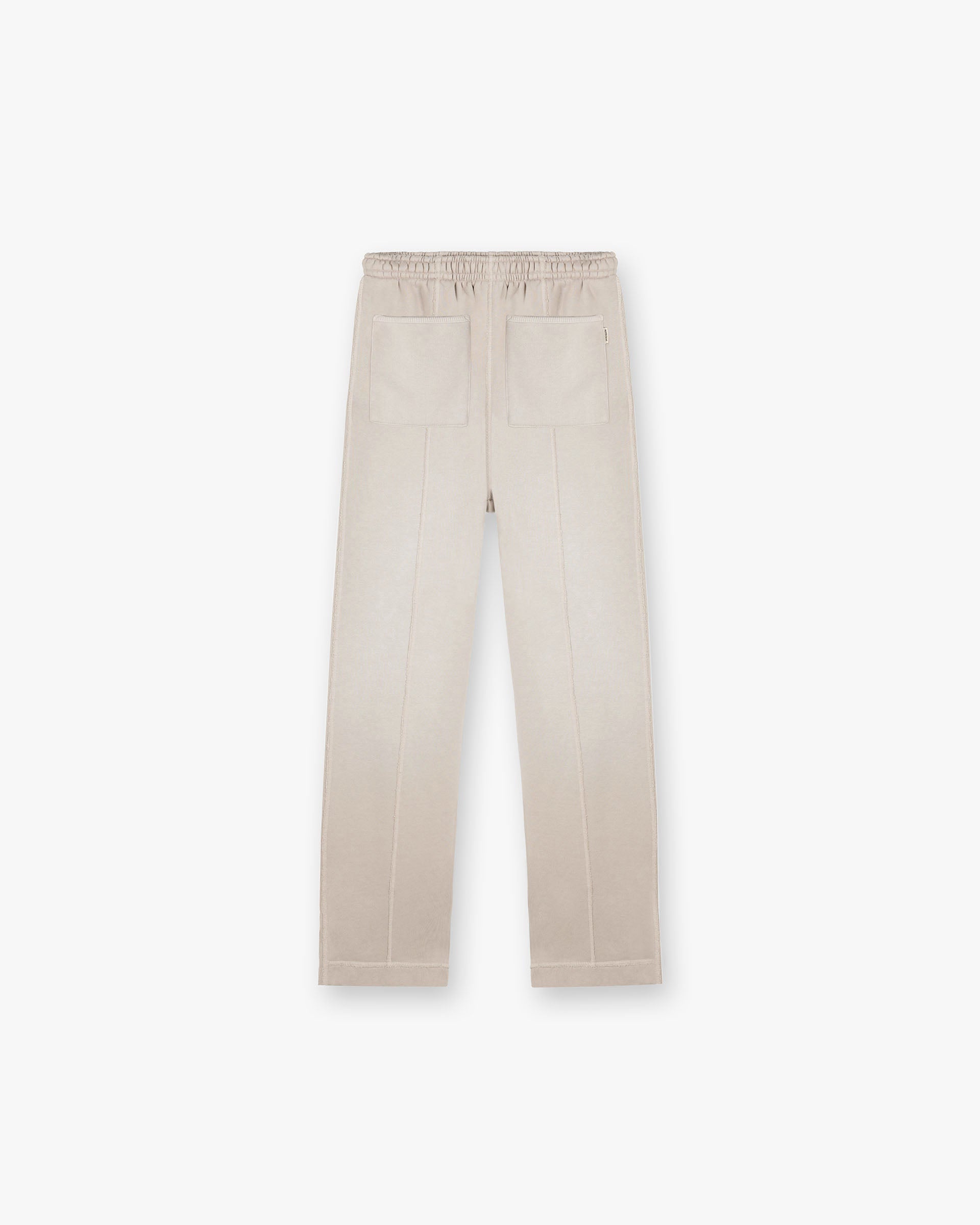 Back product image of mens oat sweatpants on a plain white background | Stepped Hem Sweatpants in Oat | Sweatpants with stepped hem and elasticated waistband | FW24 Pants | Represent Clo