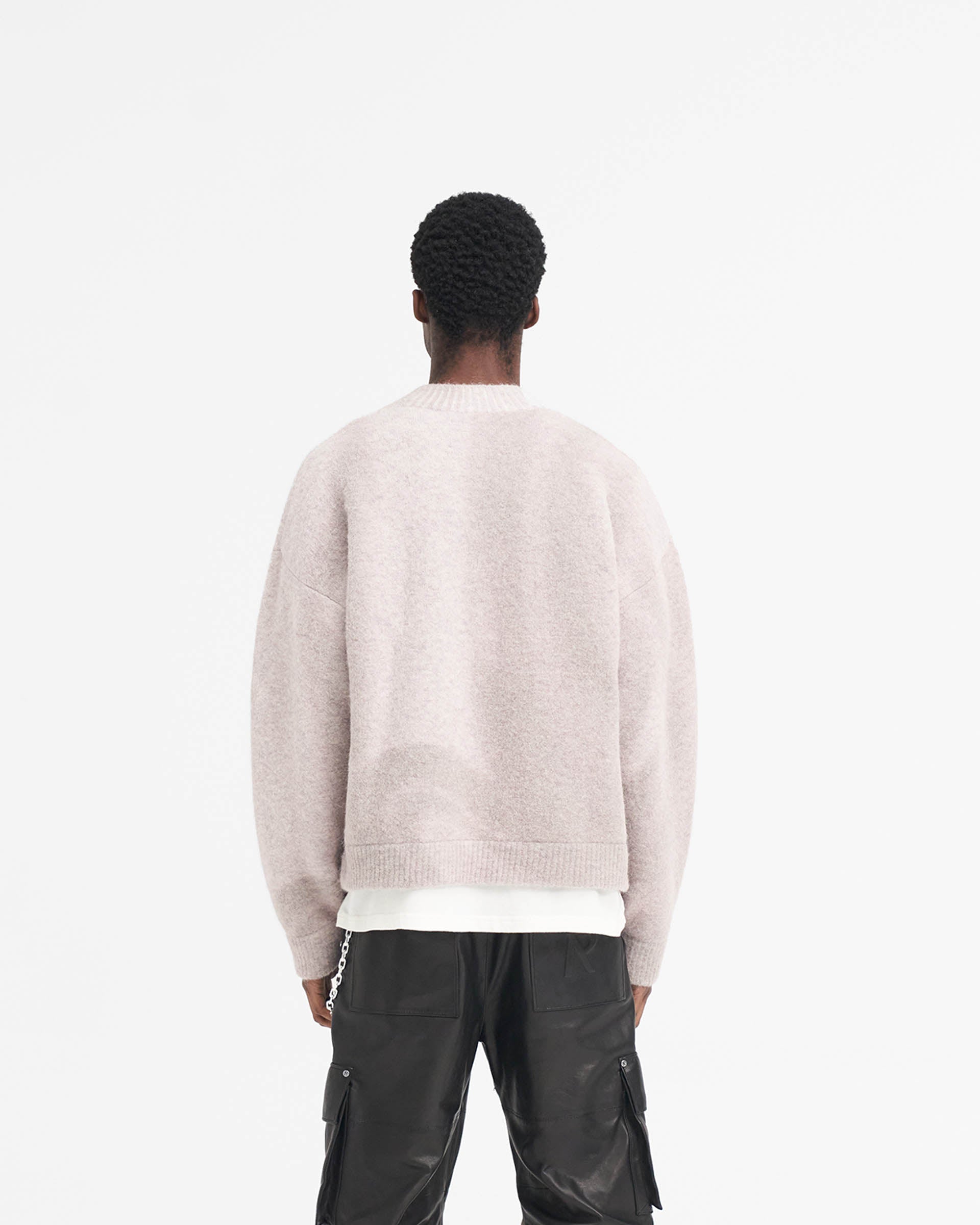 Man wearing an oversized taupe sweater on a plain white background | Sprayed Horizons Sweater in Washed Taupe | Boxy oversized knit sweater with ribbed details | SS24 Knitwear | Represent Clo