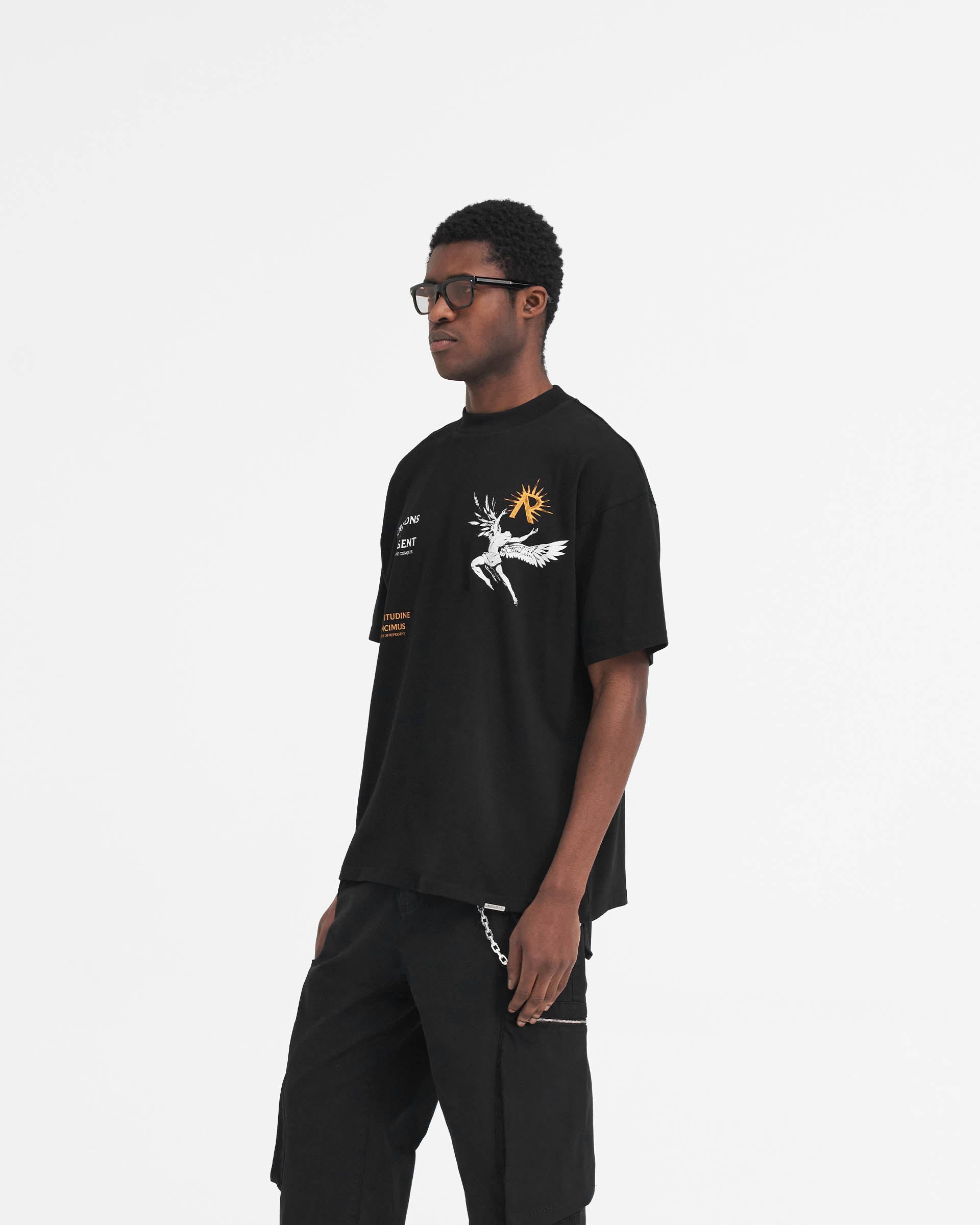 Man wearing a black t-shirt with Icarus graphic on a plain white background | Icarus T-Shirt in Jet Black | Slightly oversized fit cotton t-shirt | SS24 T-Shirts | Represent Clo