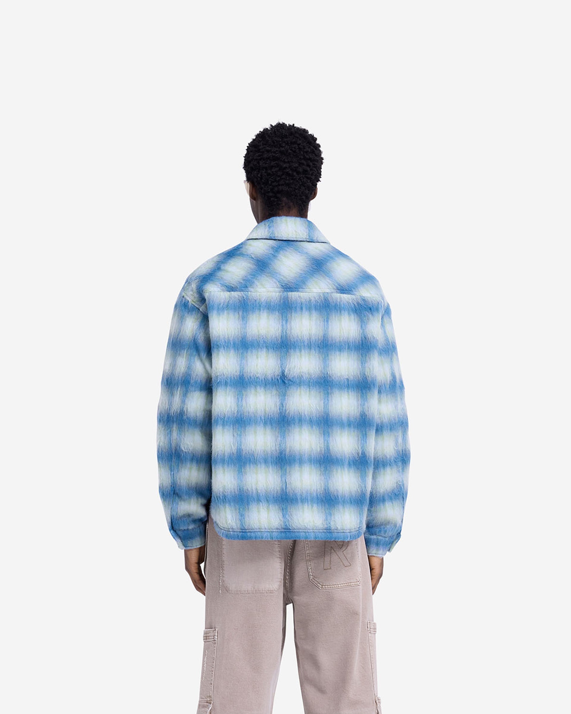 Man wearing an electric blue overshirt on a plain white background | Textured Overshirt in Electric Blue | Oversized fit with patch pockets | FW24 Shirts | Represent Clo