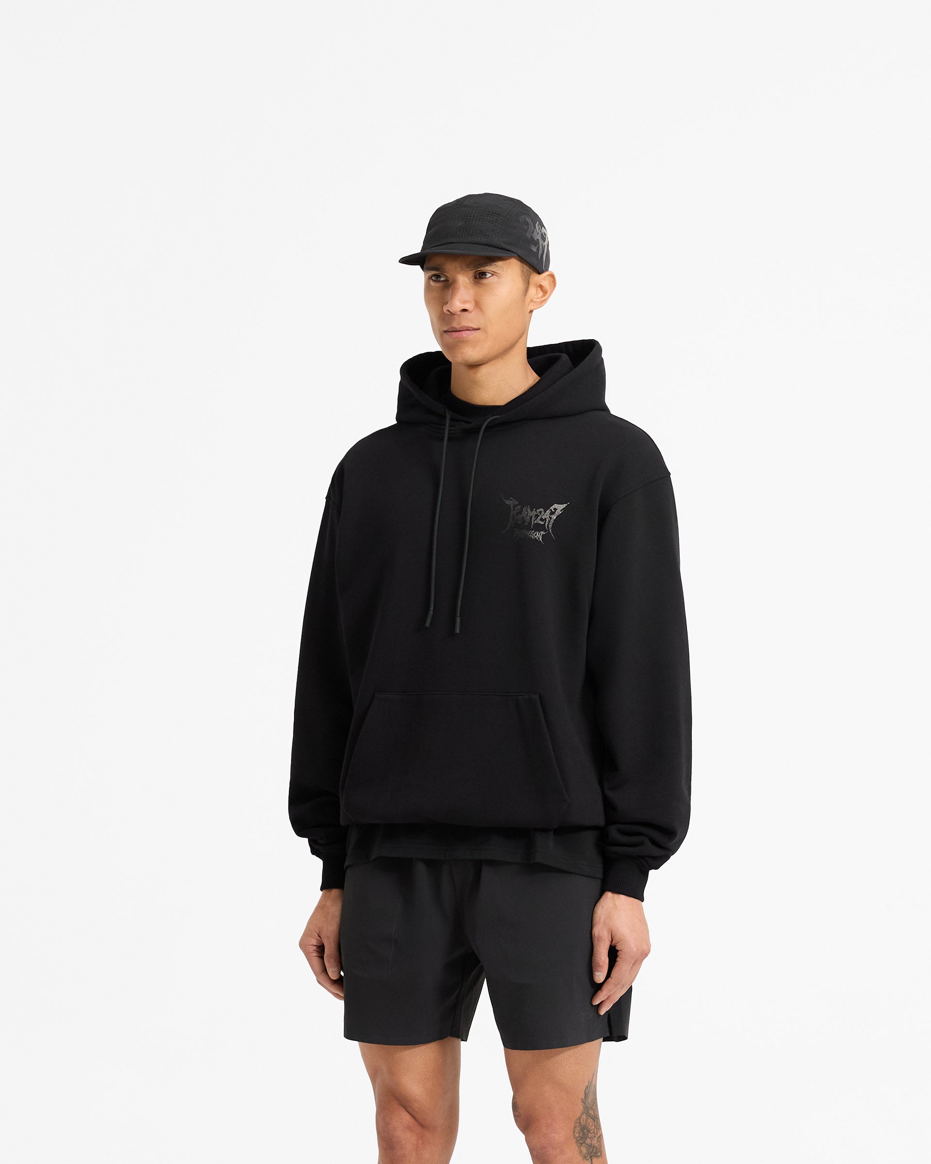 Man wearing an oversized black hoodie on a plain white background | Team 247 X END Oversized Hoodie in Jet Black | Hoodie with ribbed cuffs and co-branded graphics | 247 Hoodies | Represent Clo