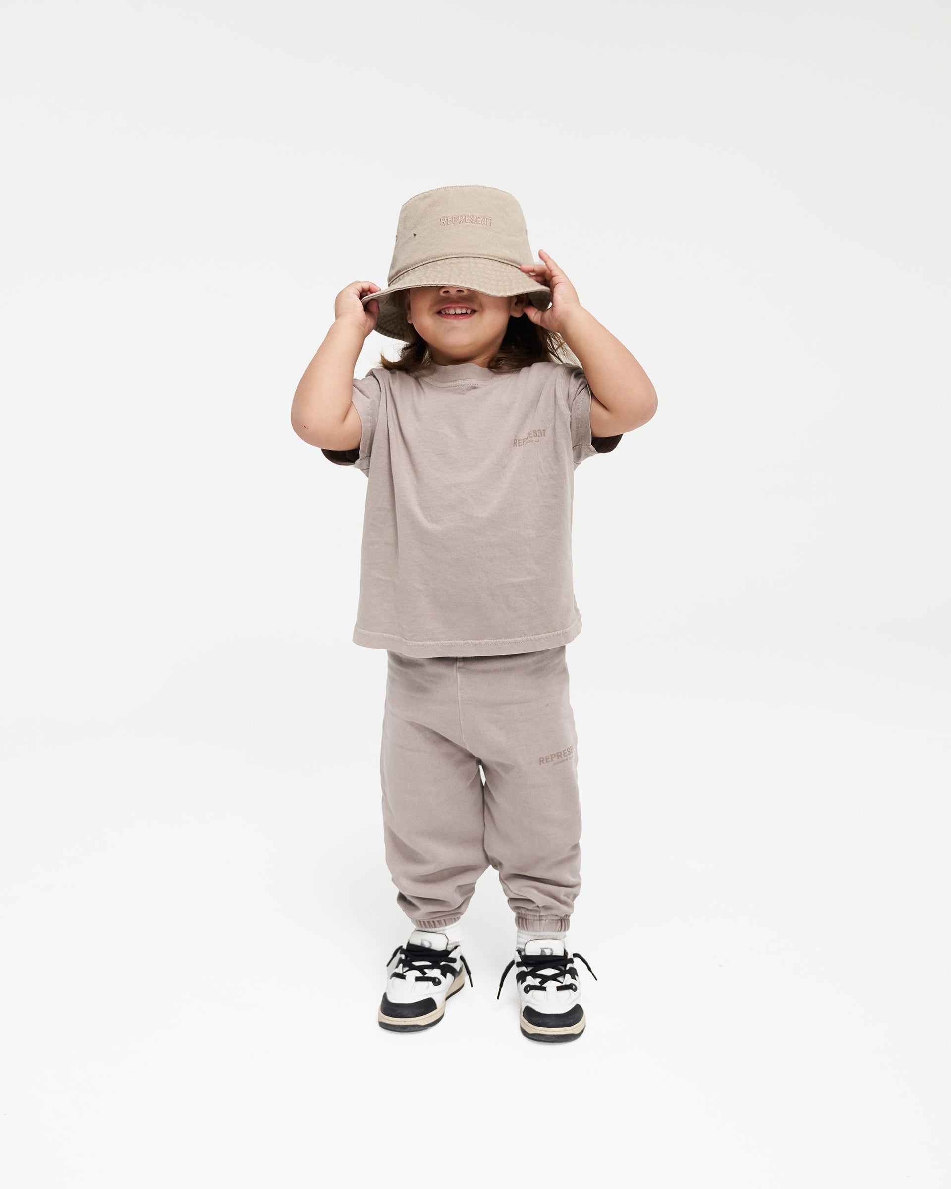 Back product image of a child's mushroom sweatpants on a plain white background | Mini Owners Club Sweatpants in Mushroom | Kids sweatpants with elasticated waistband and cuffs | Owners Club Pants | Represent Clo