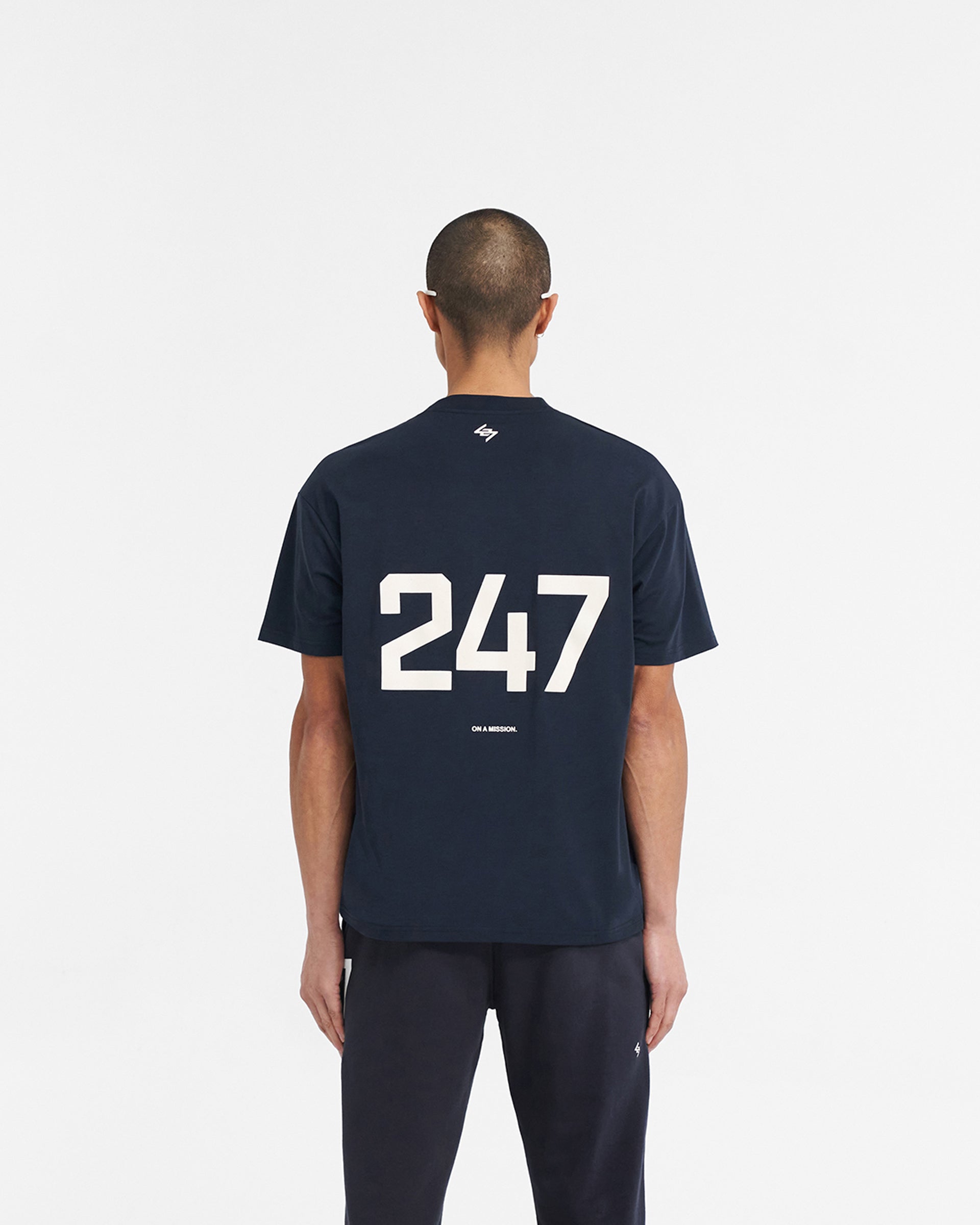Man wearing a navy oversized t-shirt on a plain white background | 247 Oversized T-Shirt in Navy | Lightweight oversized t-shirt with quick dry fabric | 247 T-Shirts | Represent Clo